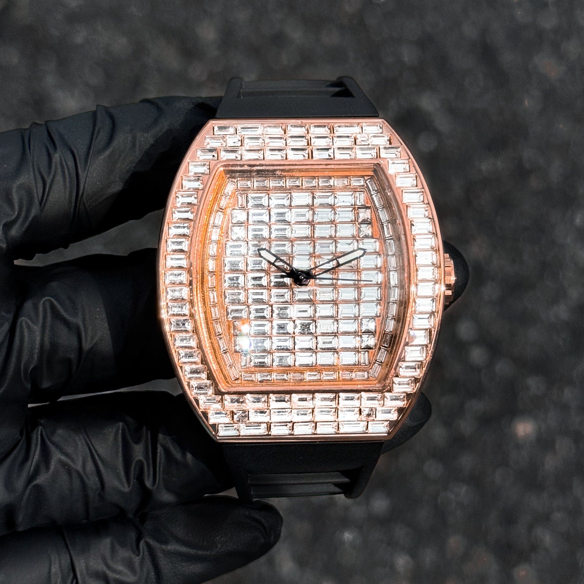 Men’s rose gold 43mm tonneau watch with fully iced baguette crystal layout and silicone strap.