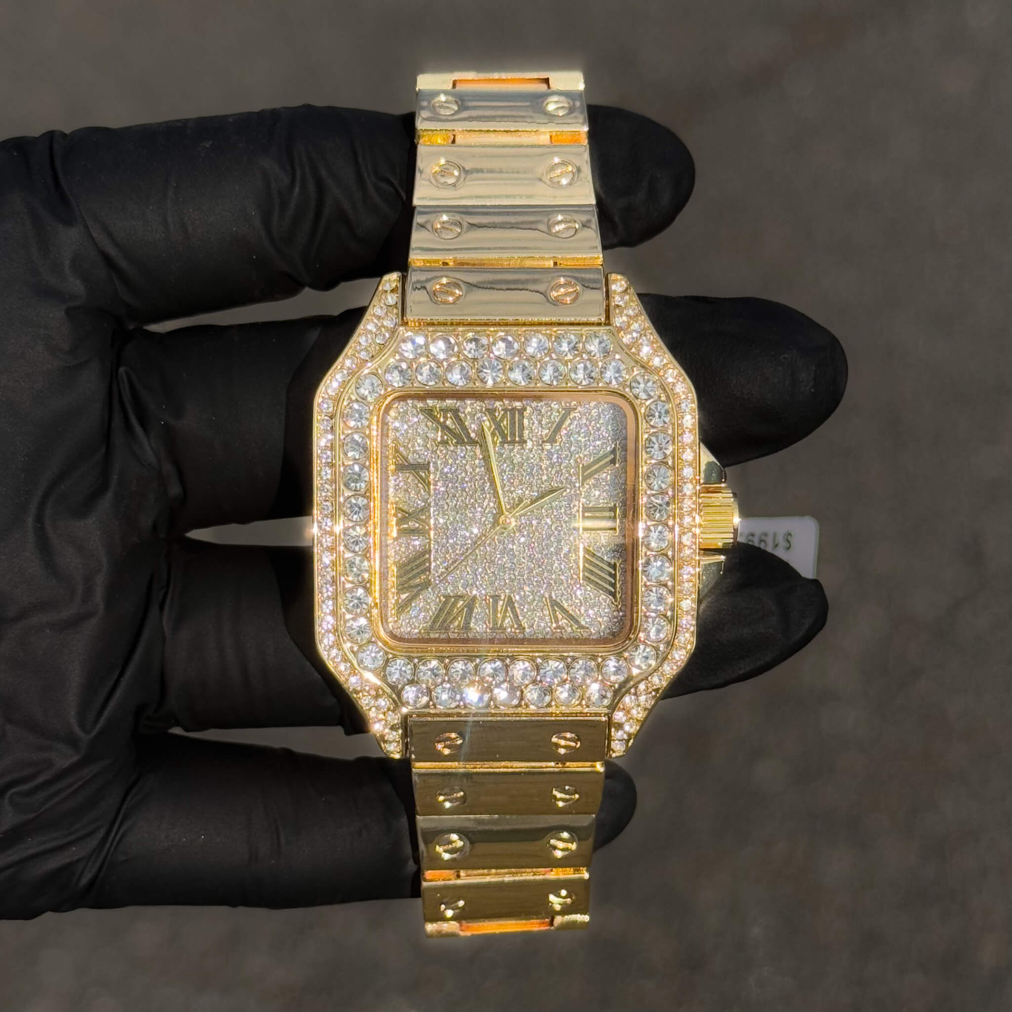 Gold 40mm iced out square dial men’s watch with crystal bezel and sleek metal band.