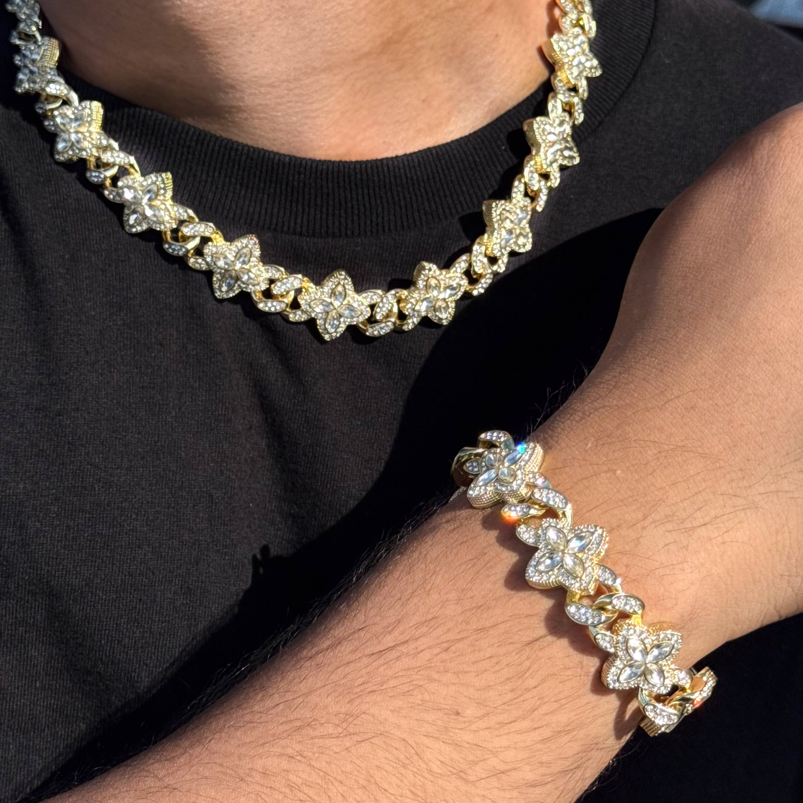 Gold 2-piece iced clover necklace and bracelet set with sparkling clear stones and clover links.