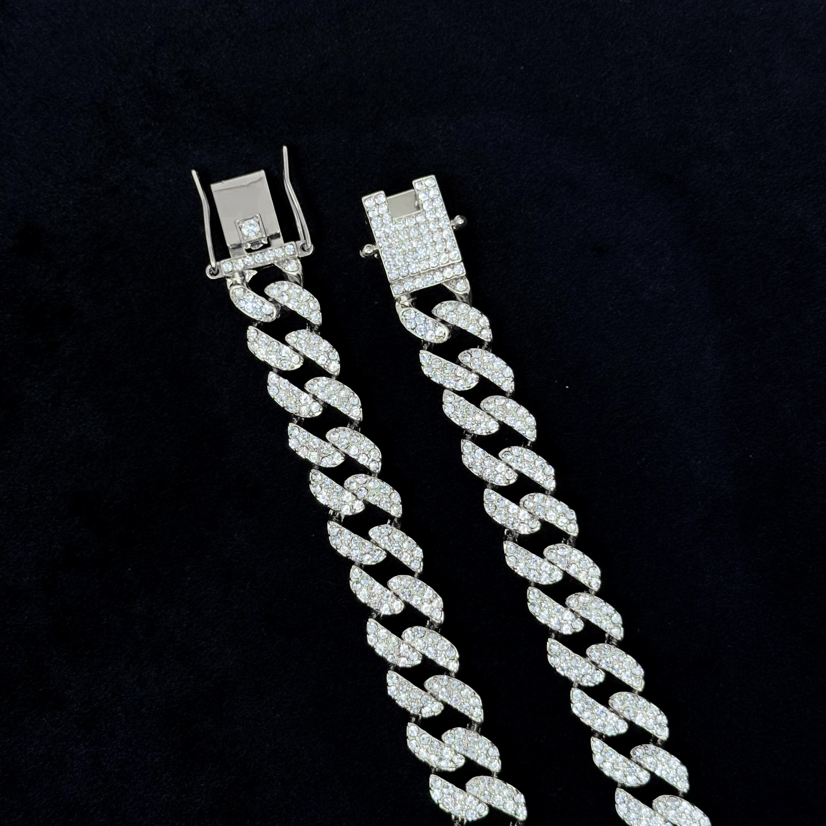 Close-up of 13mm Iced Out Cuban Chain silver clasp detail showing pavé CZ diamonds and locking mechanism.