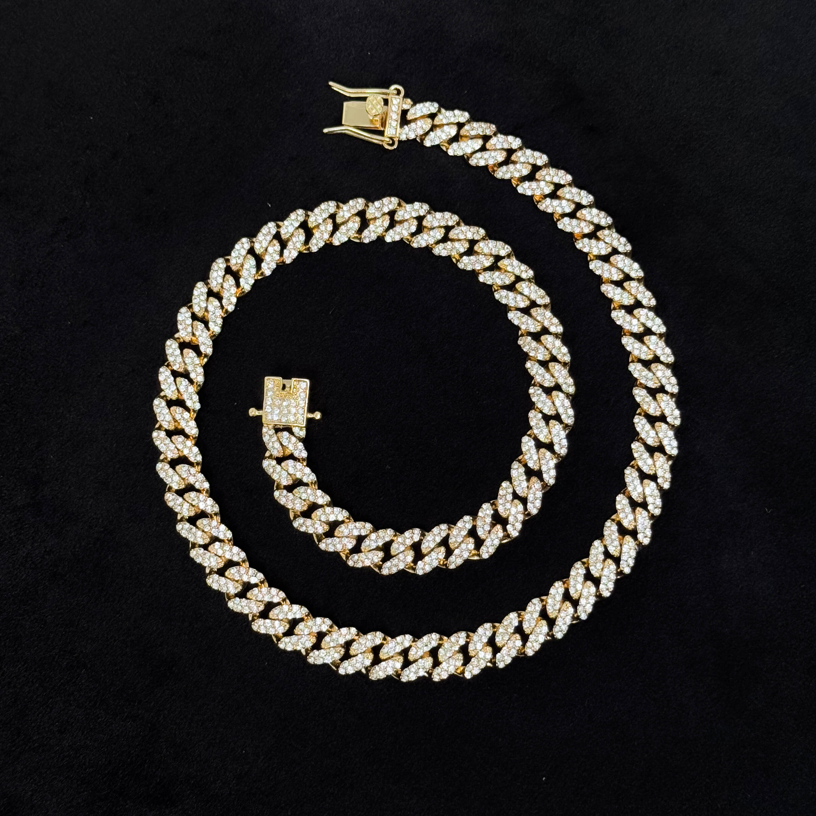 9mm Iced Out Cuban Chain gold necklace laid flat, full pavé links and secure iced clasp on black background.
