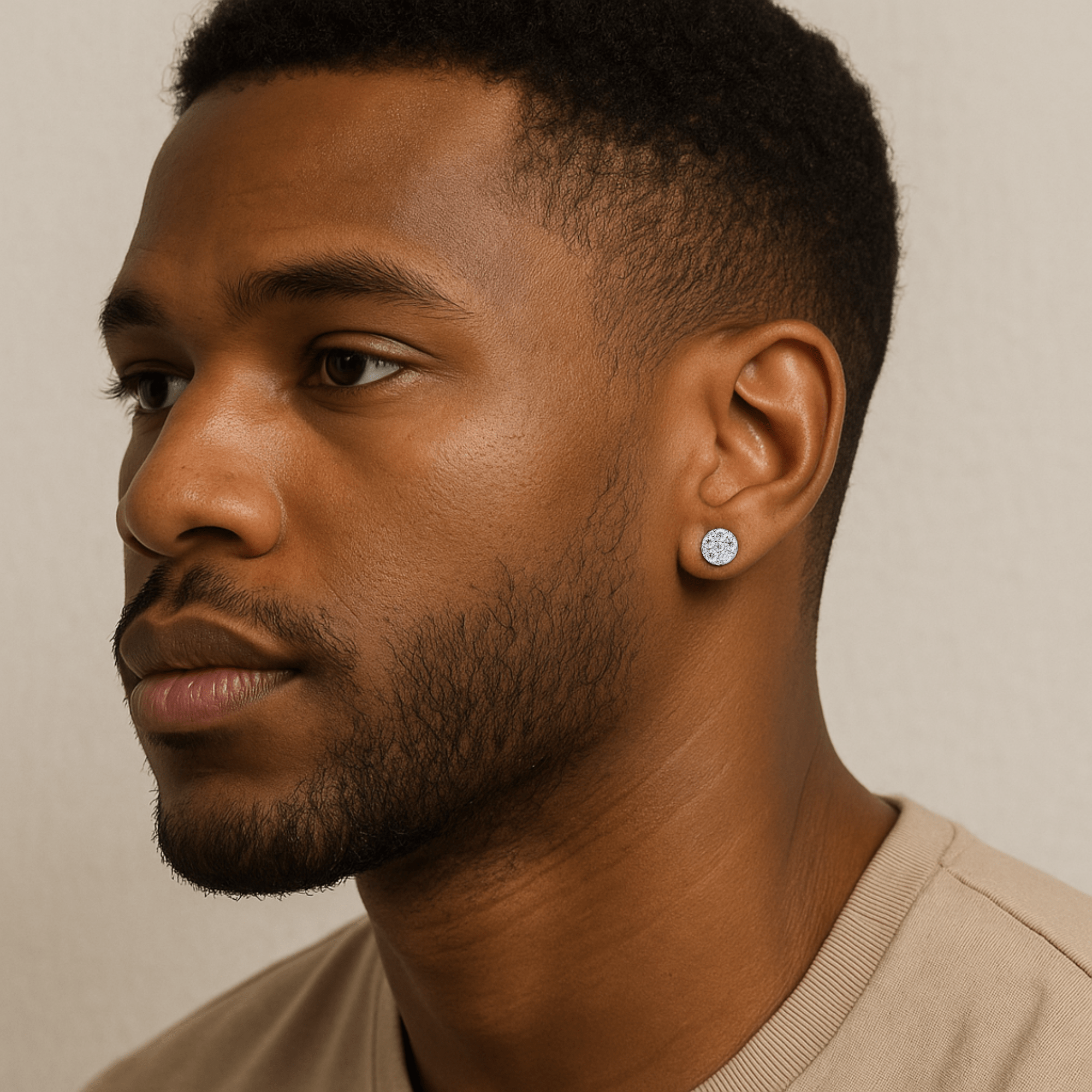 Man wearing 7mm round moissanite cluster diamond stud earrings in sterling silver for size reference.