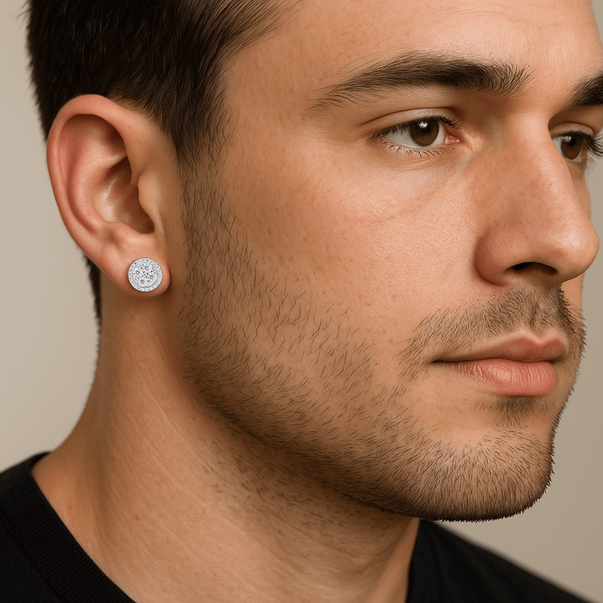 Men’s 9mm round moissanite cluster stud earrings in sterling silver shown worn on ear.