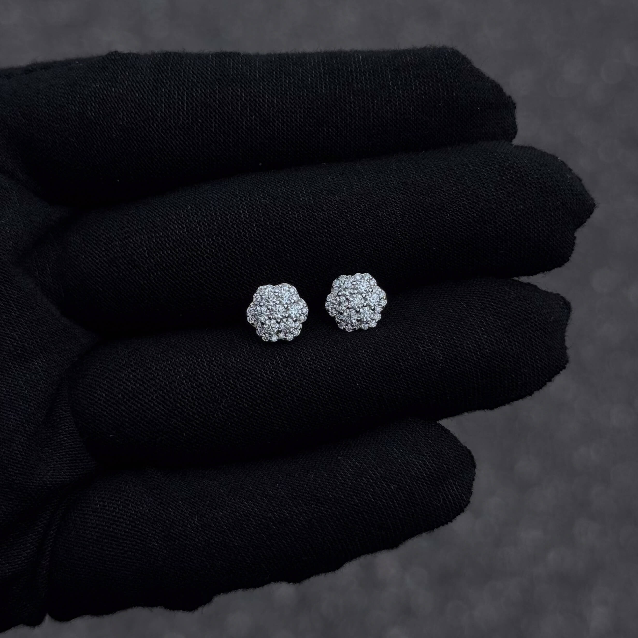 Close-up of 9mm moissanite flower cluster earrings with shimmering diamond detail.