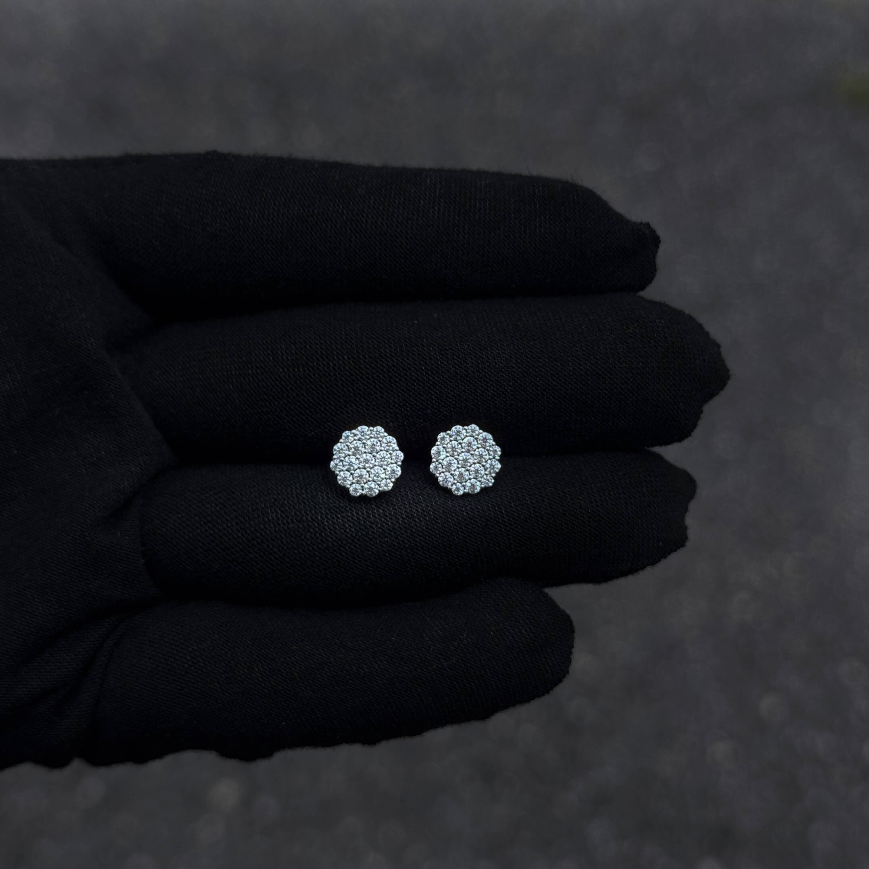 Small 9mm sterling silver Moissanite cluster stud earrings displayed on black glove.