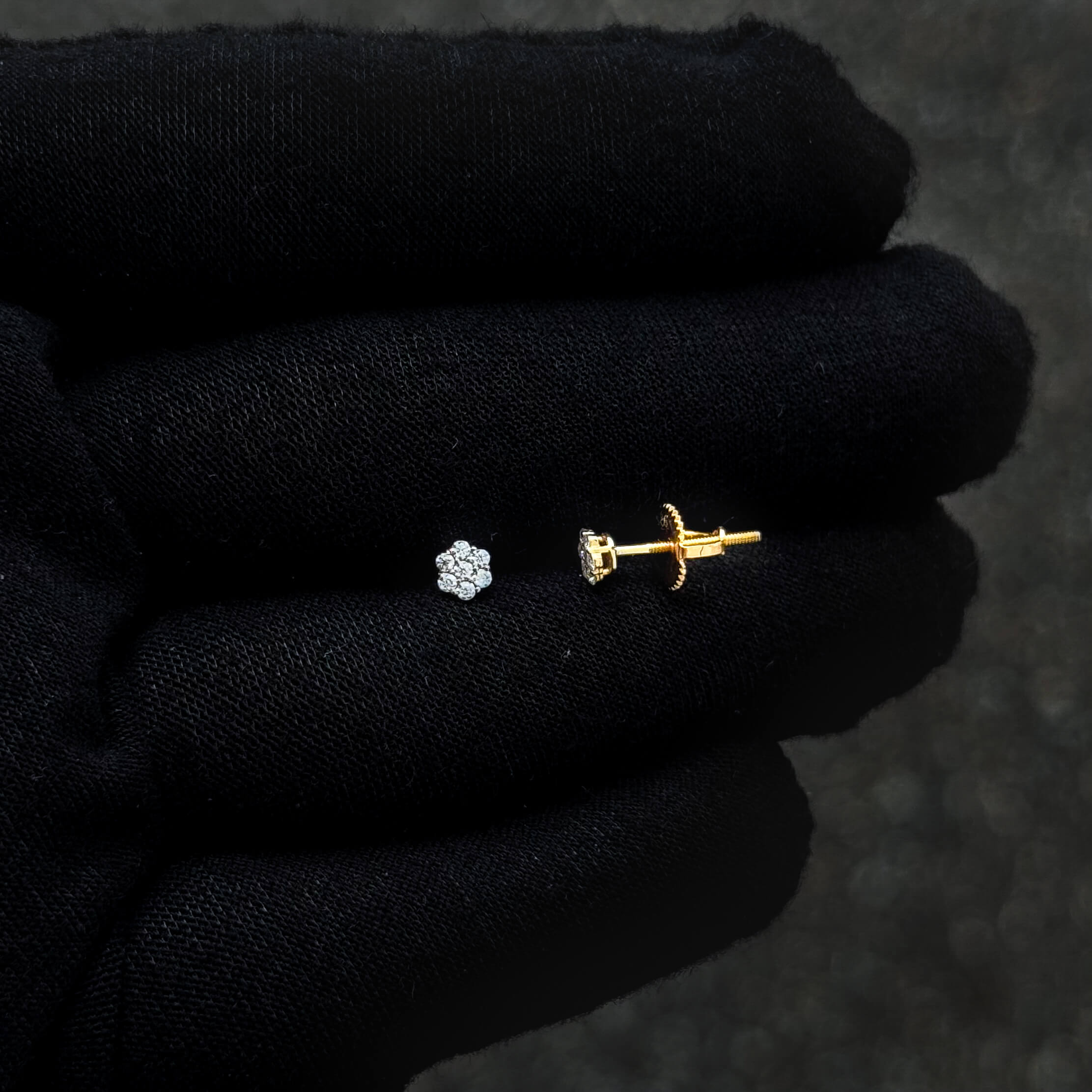 Gold-plated moissanite cluster earring with screw-back post displayed on black glove.