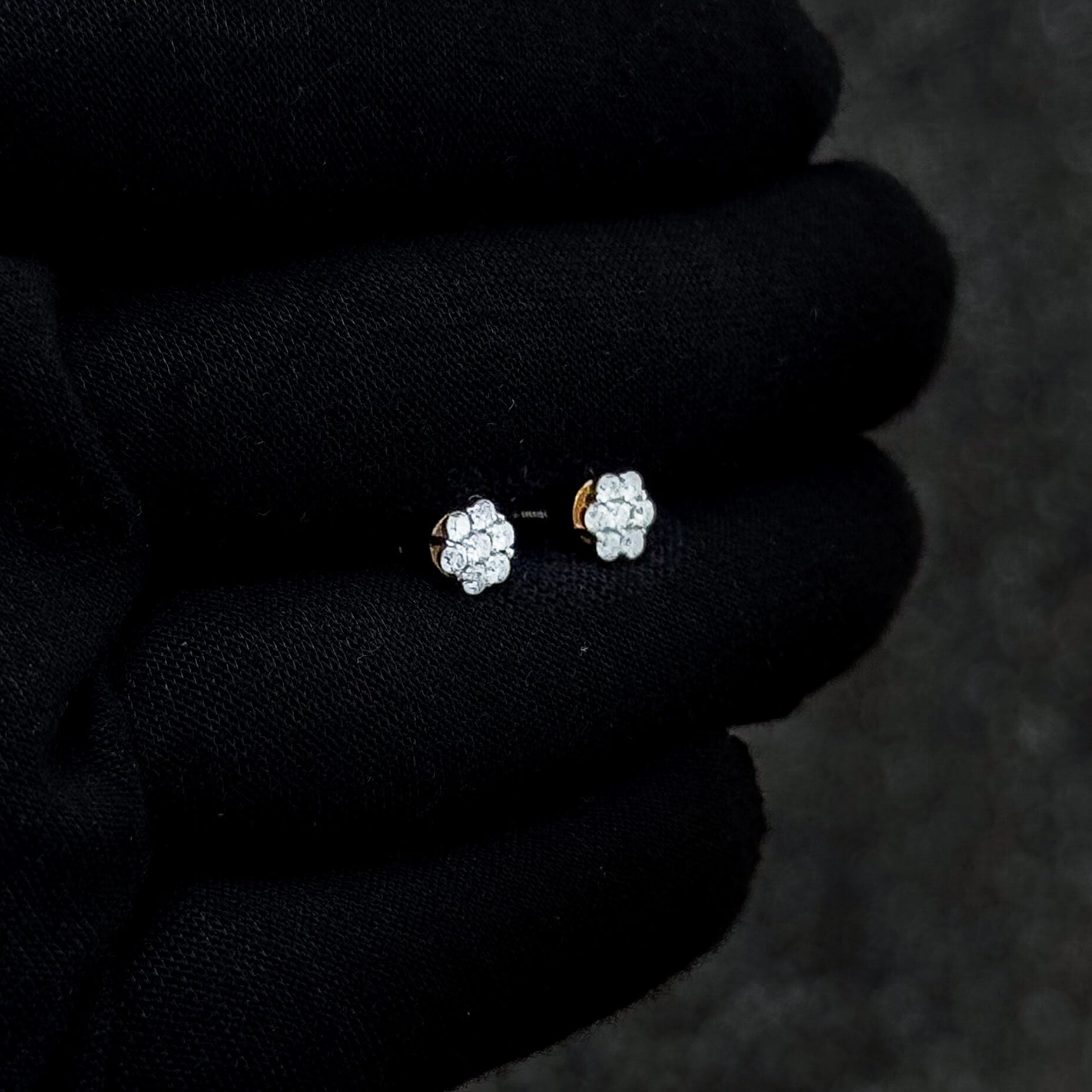 Small 6mm Moissanite cluster diamond stud earrings with gold backing displayed on black glove.