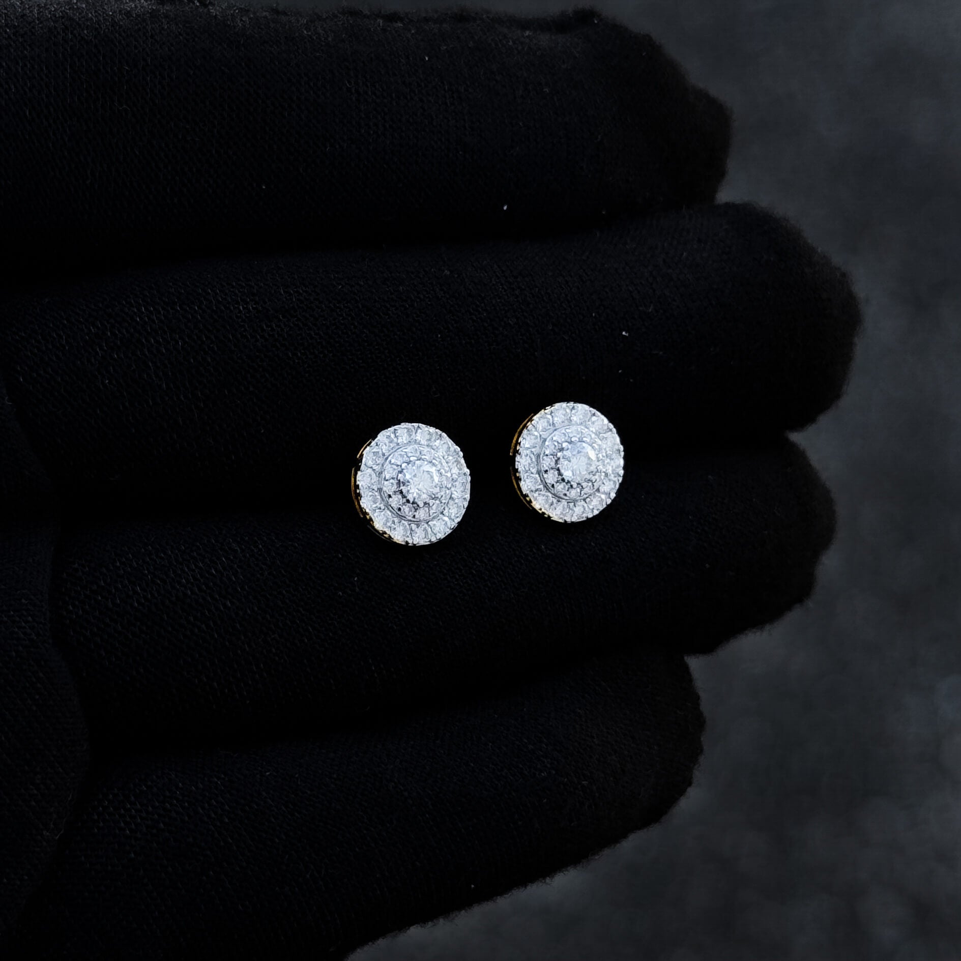 9mm moissanite halo cluster diamond stud earrings in sterling silver displayed on black glove.