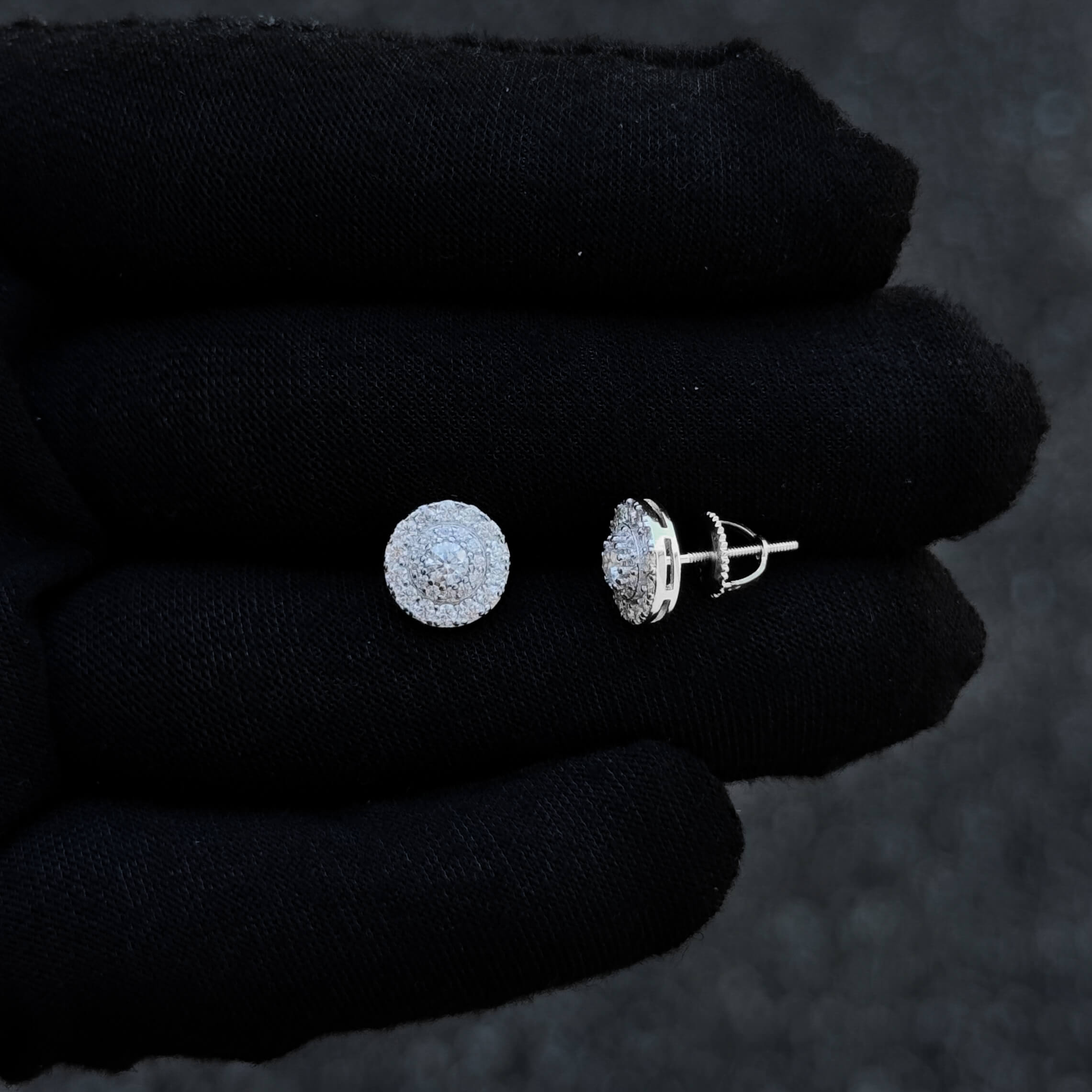 Sterling silver 9mm moissanite cluster stud earring with screw-back post shown on glove.