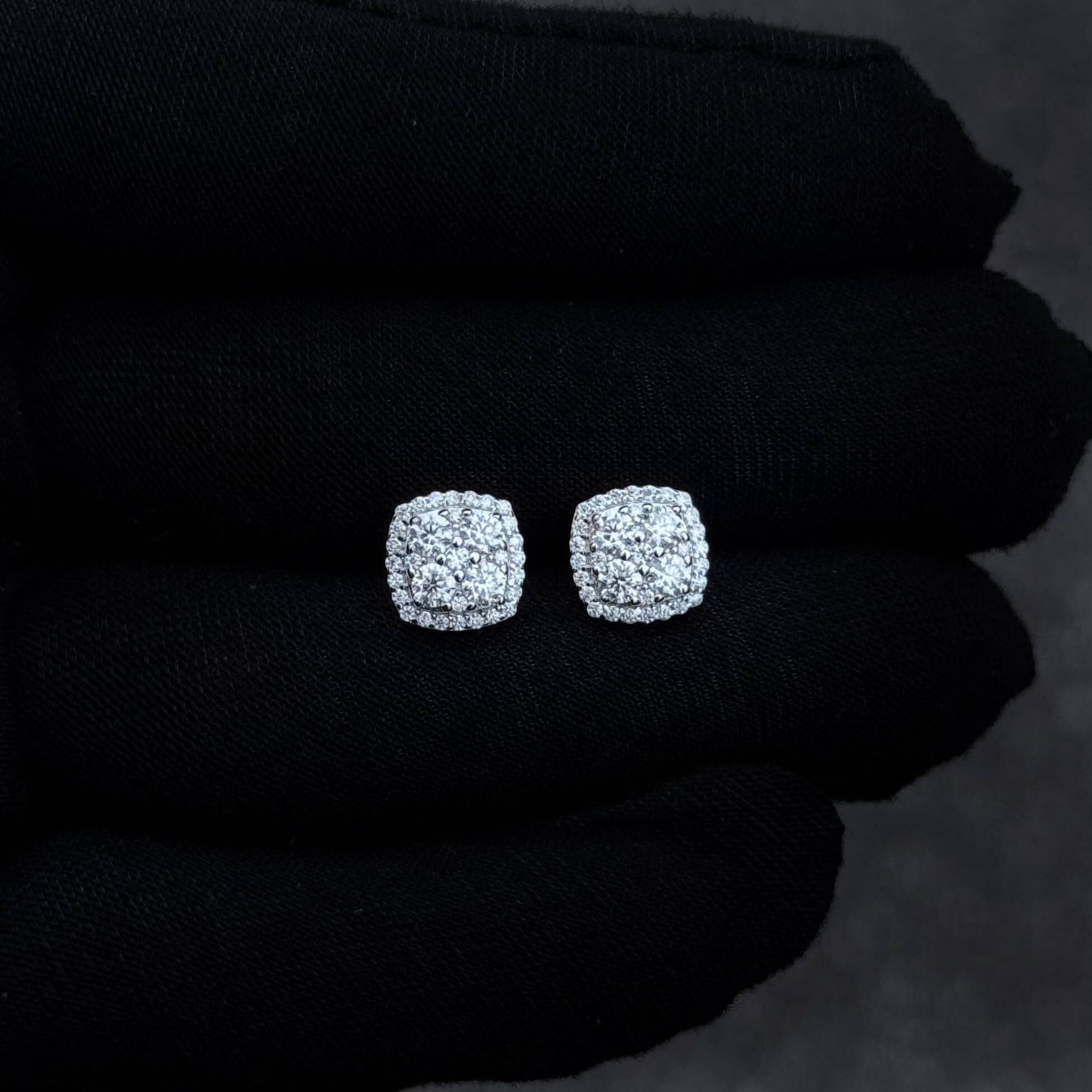 9mm sterling silver moissanite cluster stud earrings shown on black glove to display sparkle.