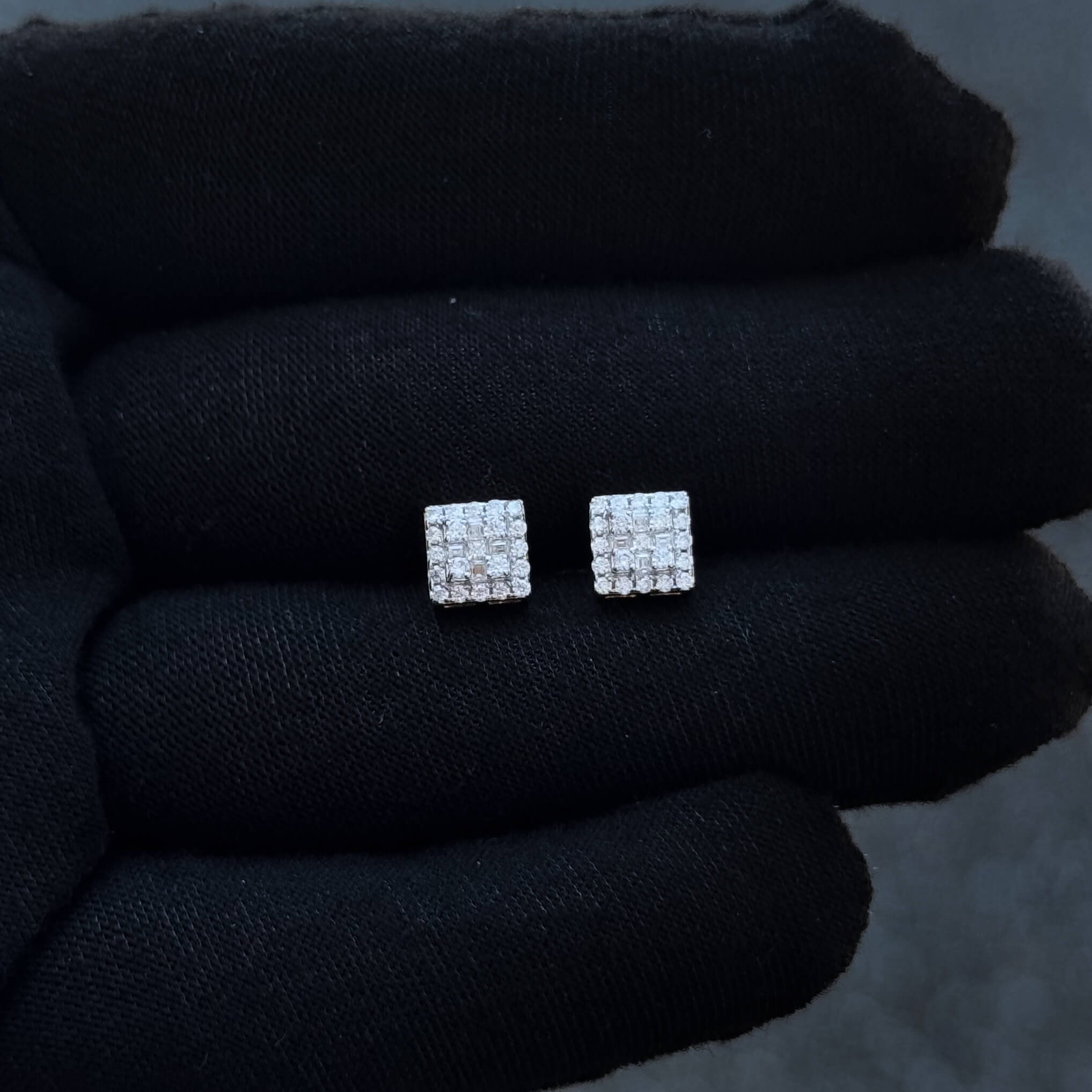 7mm sterling silver moissanite cluster earrings with 0.37ct diamonds shown on black glove.