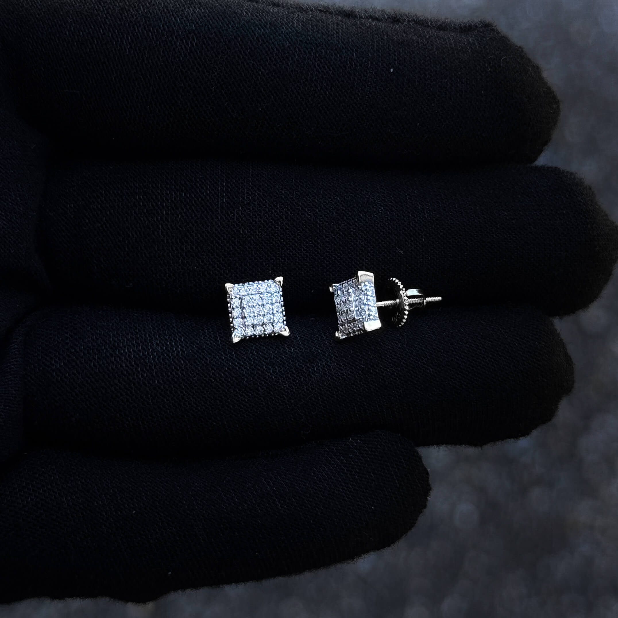 7mm Moissanite square stud earrings with screw backs showcased on black glove close-up.
