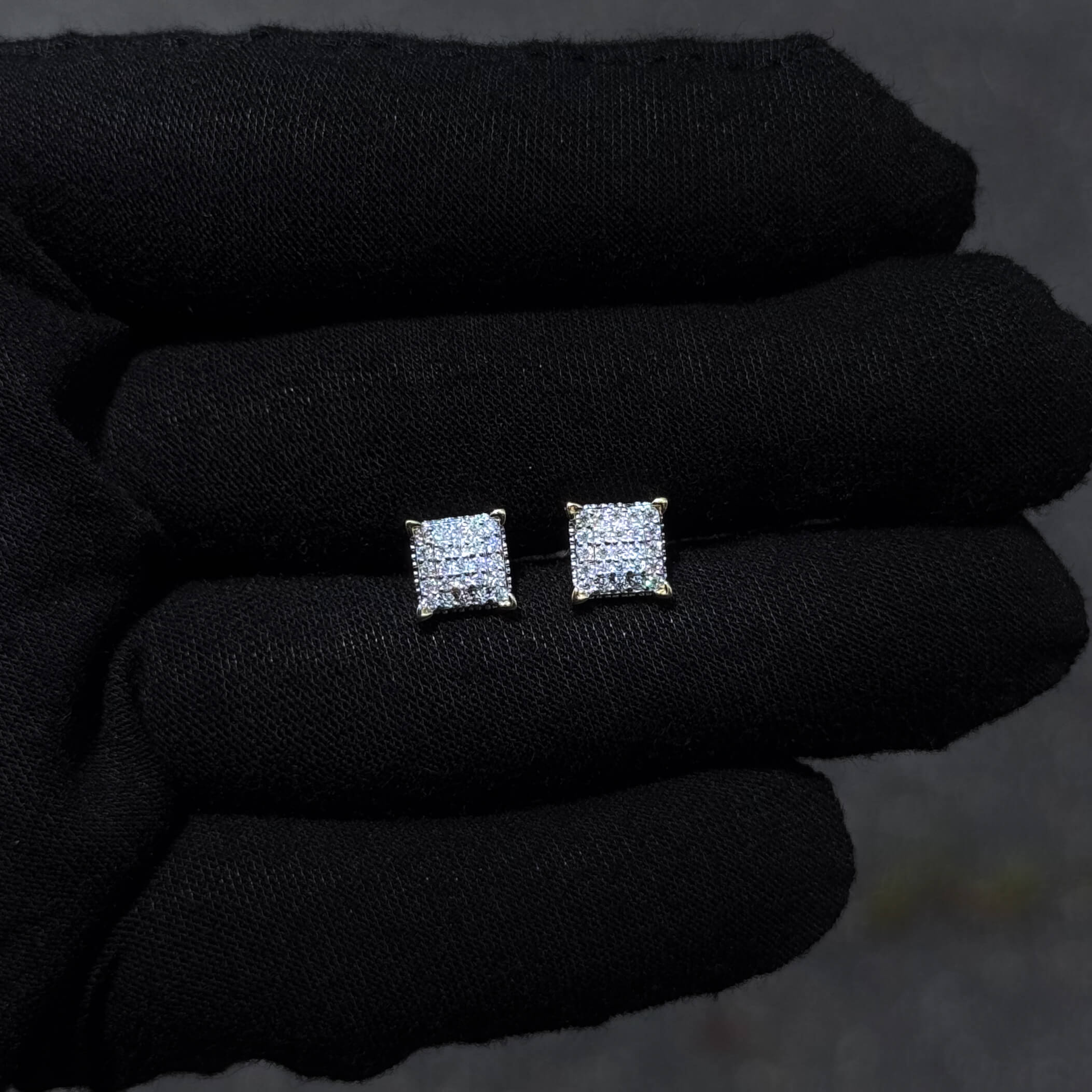 7mm square Moissanite diamond stud earrings shown on black glove.