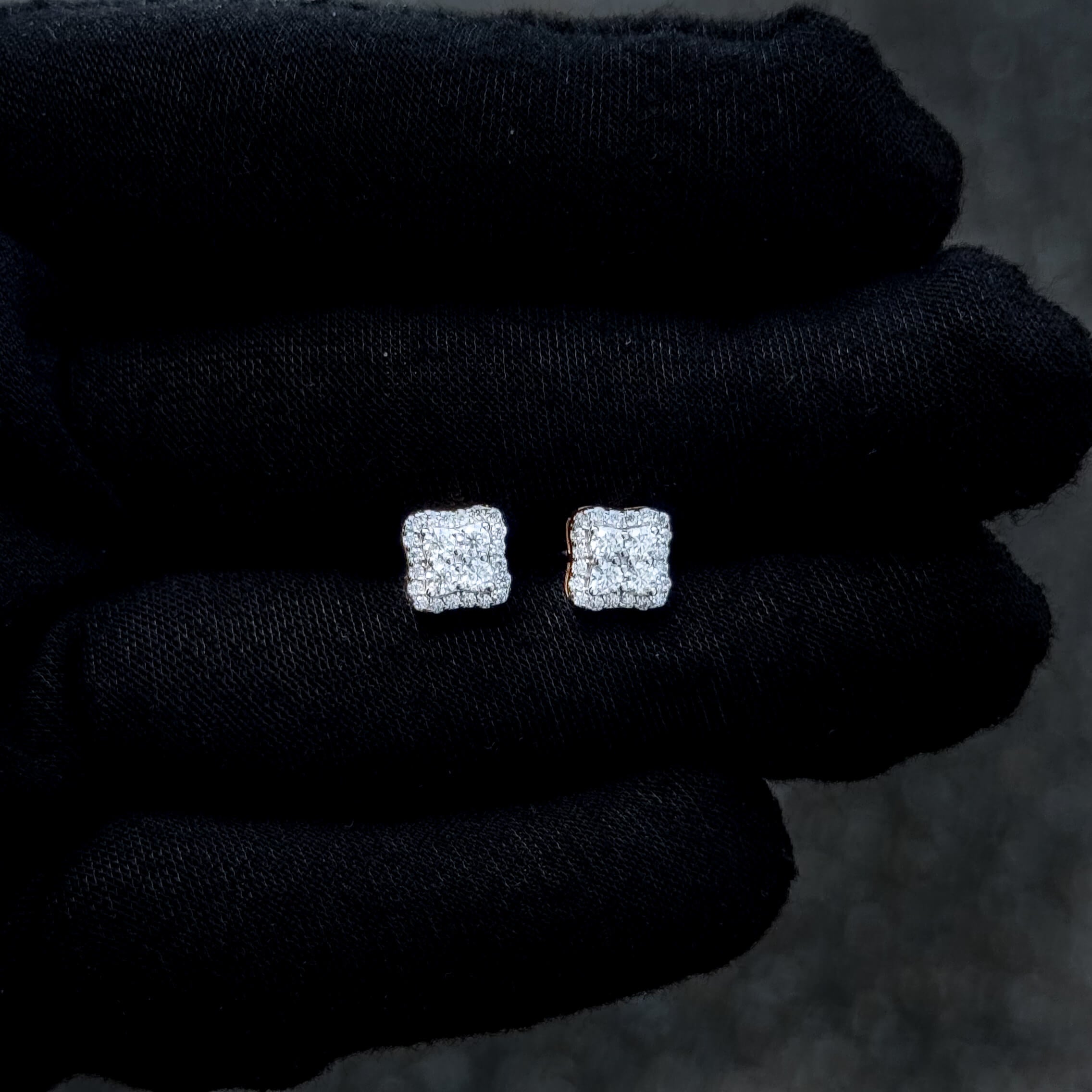 Sterling silver 7mm moissanite cluster stud earrings with sparkling cushion halo on glove.