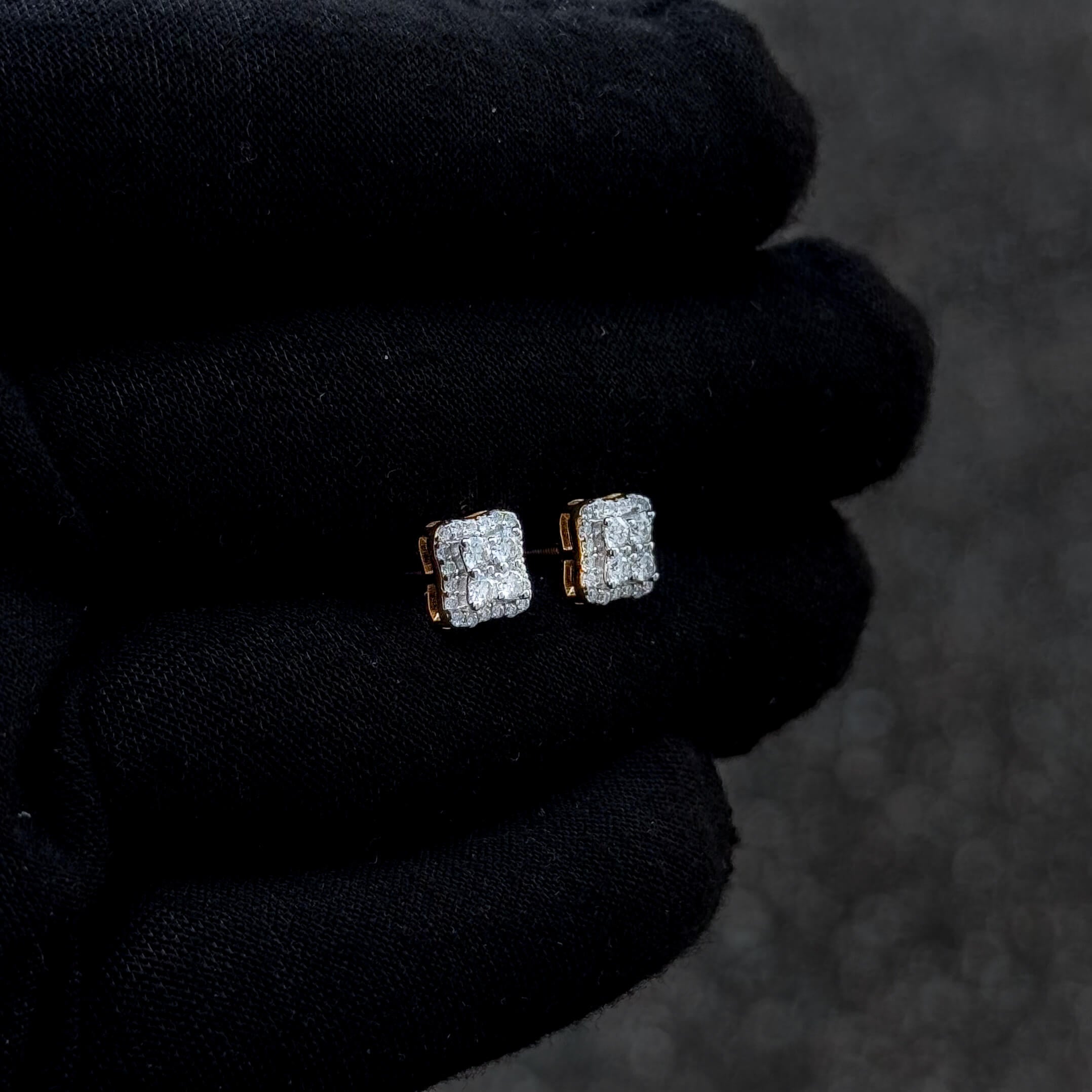 Gold-accent 7mm moissanite cushion studs with diamond cluster center shown on black glove.