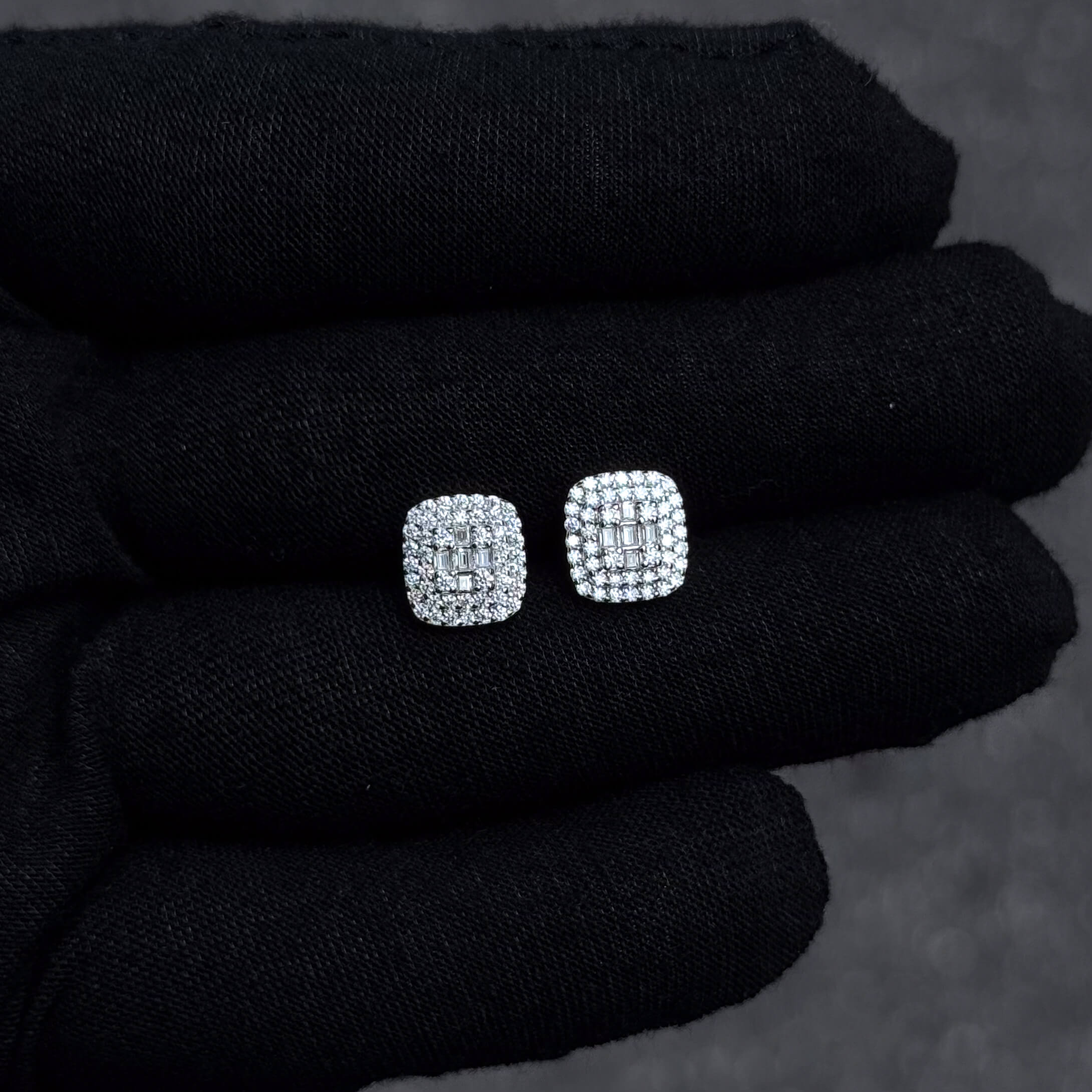Sterling silver 9mm square cluster moissanite earrings shown on black glove to display sparkle.