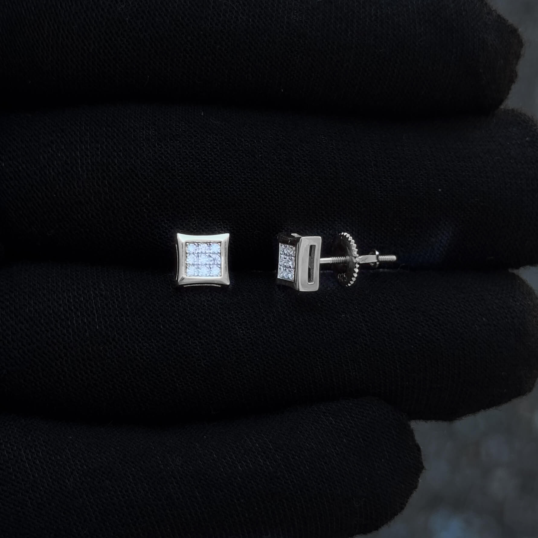 Sterling silver 6mm square moissanite cluster earrings shown on black glove with screw backs.