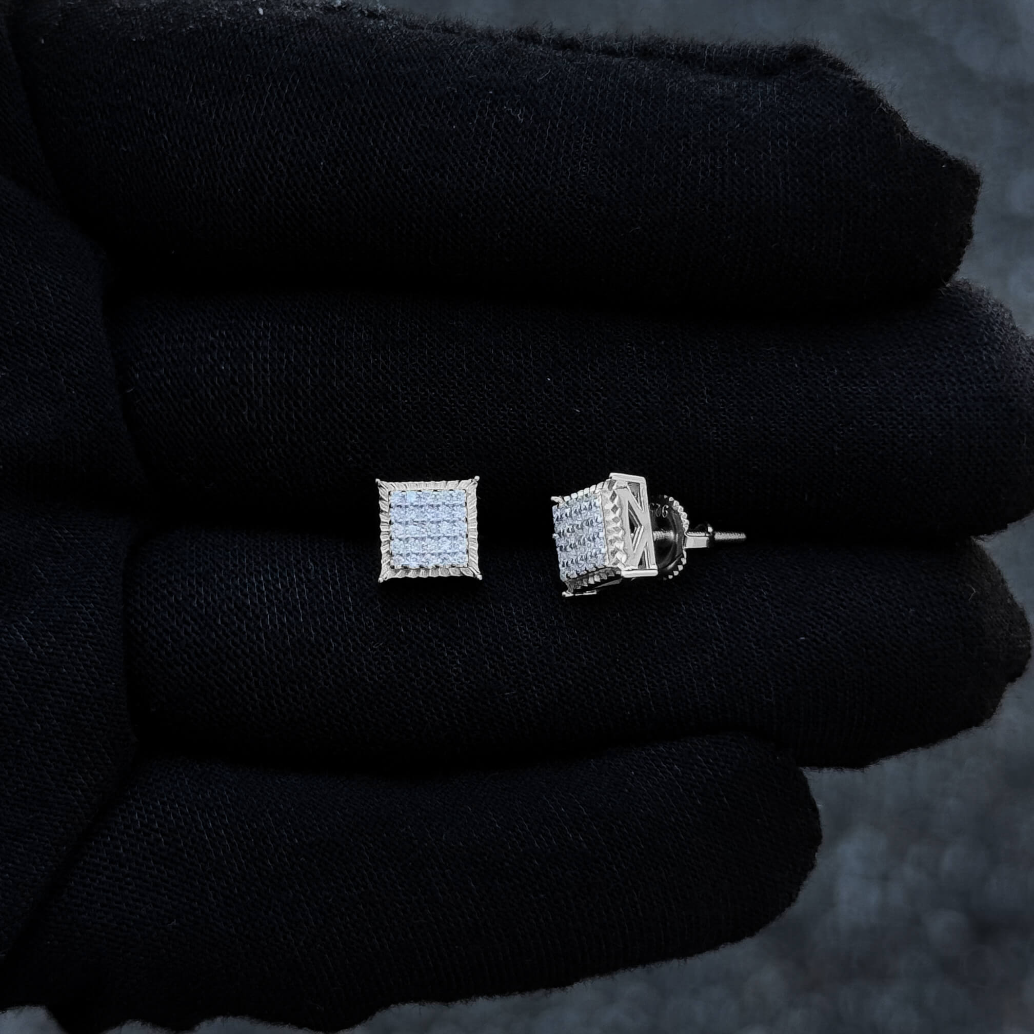 7mm Moissanite square cluster studs with sterling silver screw-back posts displayed on glove.