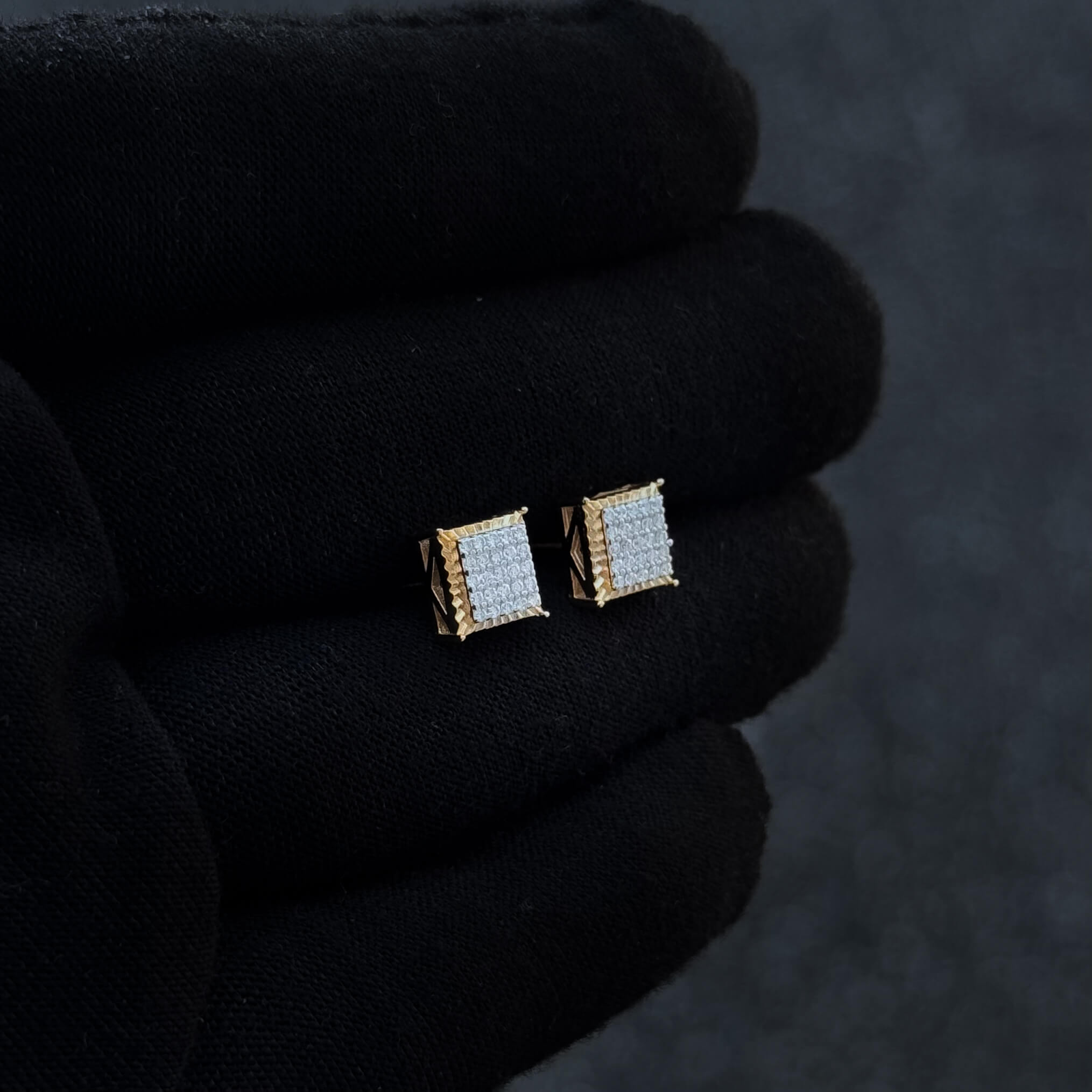 Side-angled view of gold 7mm Moissanite cluster earrings with square pavé diamond design.