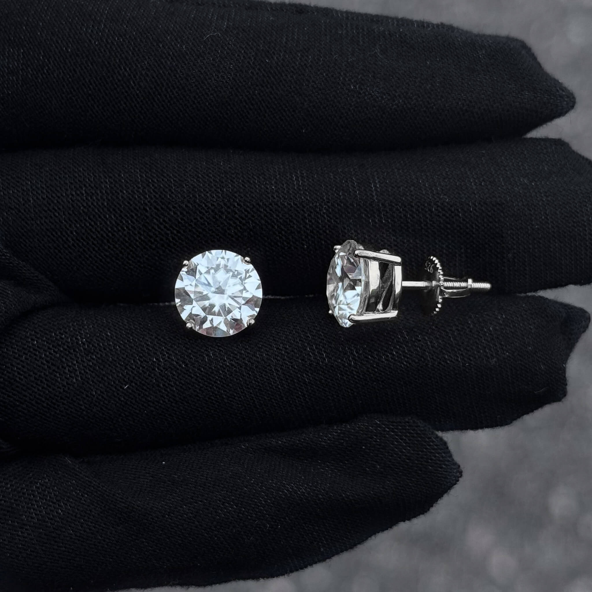 9mm moissanite diamond studs in sterling silver shown on glove, round 6.2ct stones side profile.