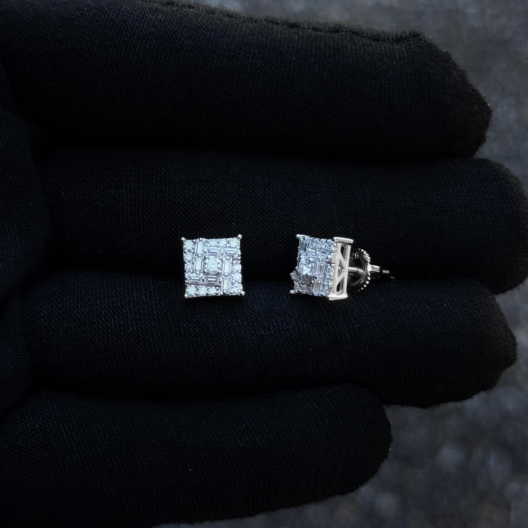 Front and side view of 9mm square moissanite cluster earrings with screw-back posts on glove.