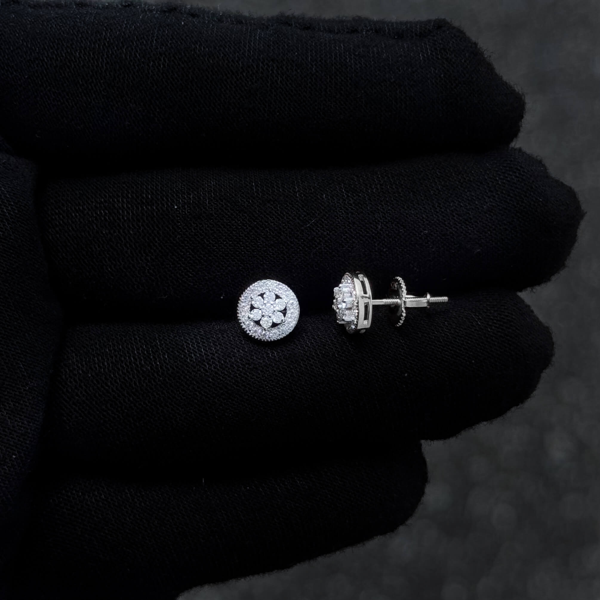 Sterling silver moissanite stud earring with diamond cluster and screw-back post design.