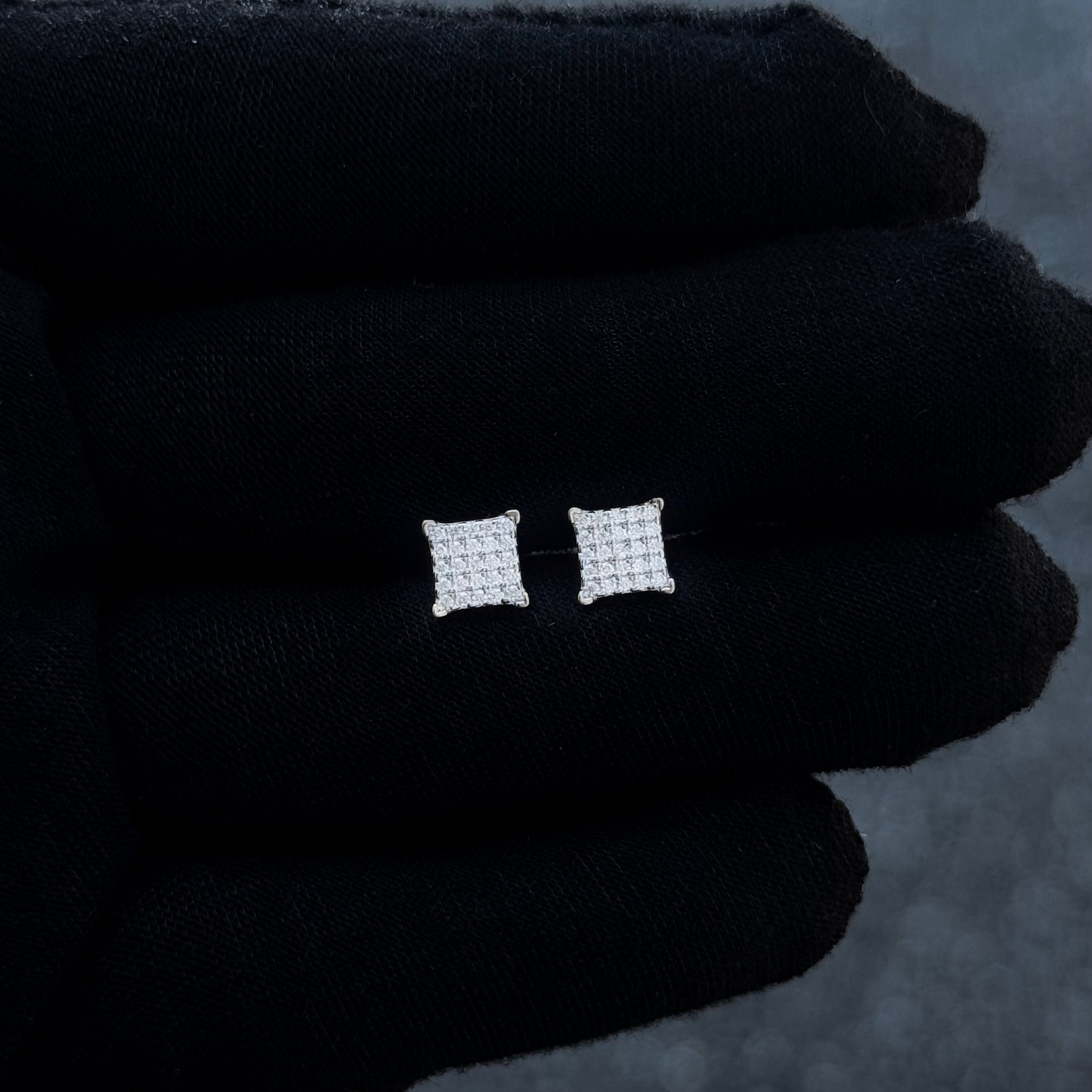 Small square 6mm Moissanite cluster diamond stud earrings shown on black glove for scale.