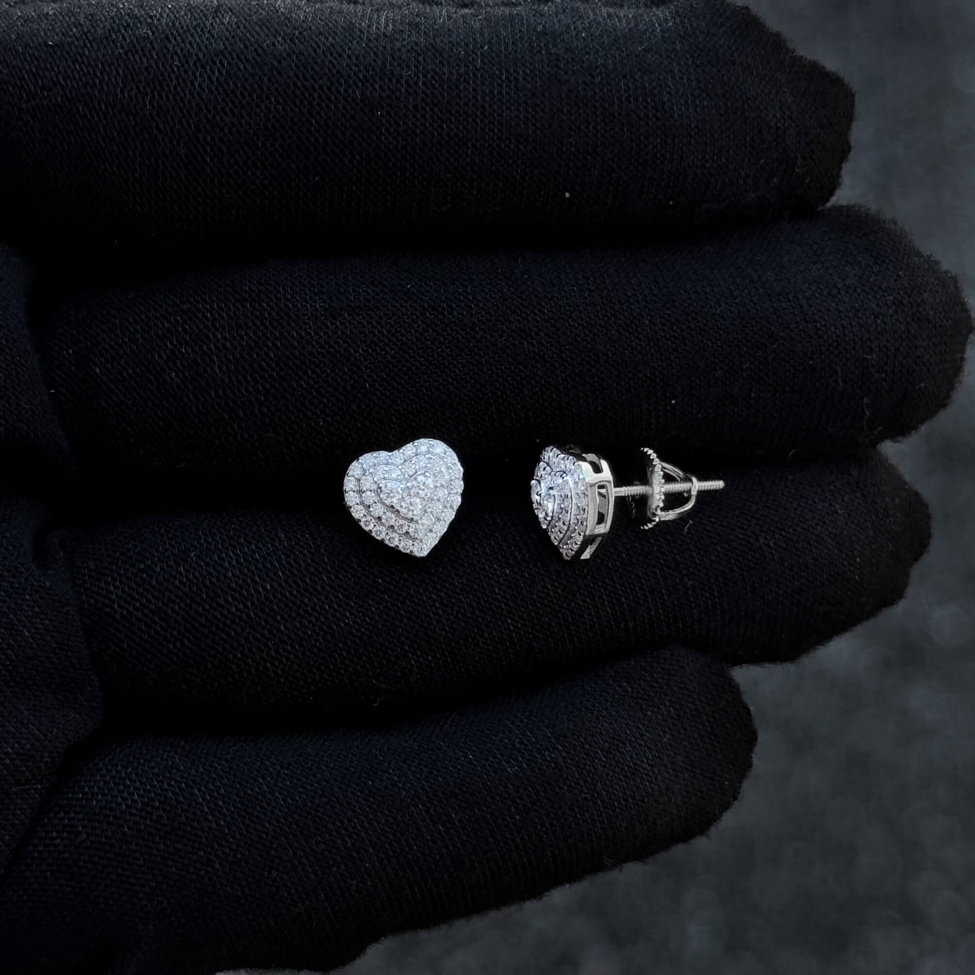 Sterling silver 9mm heart moissanite cluster earrings with screw-back posts on display.