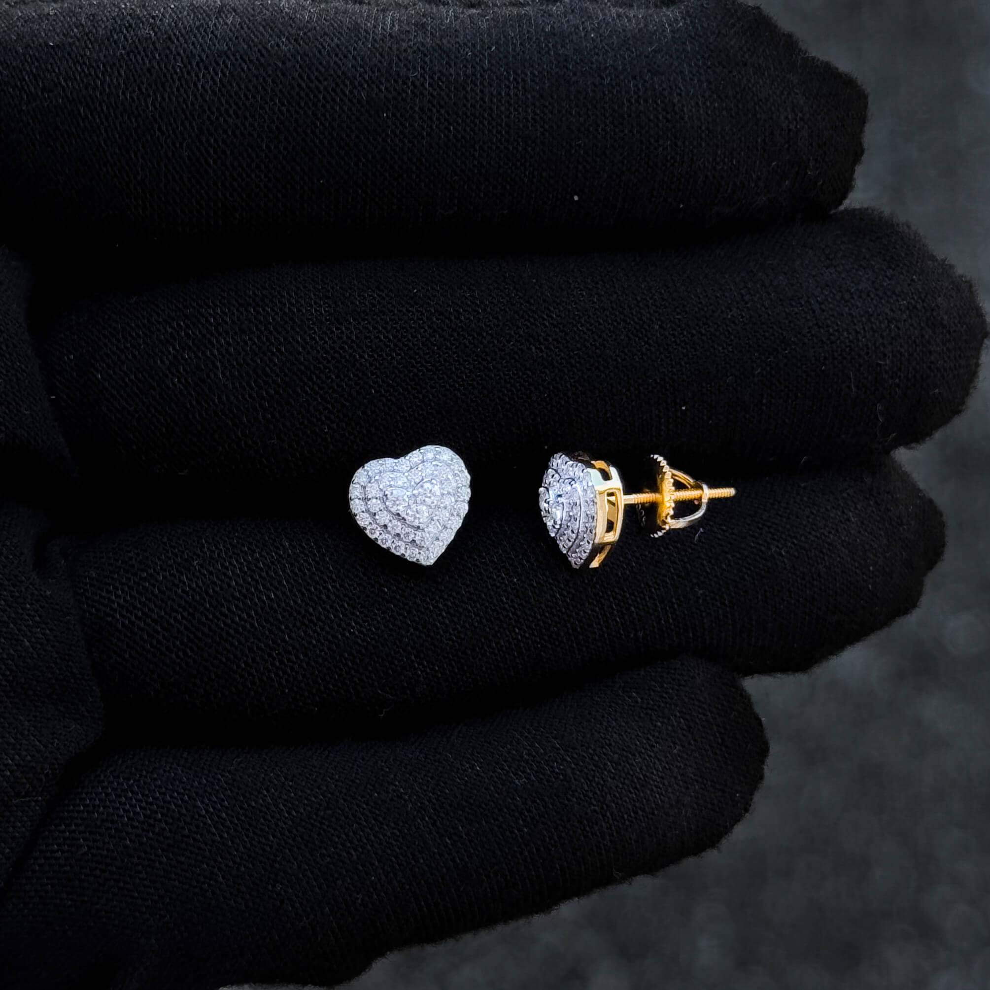 Side view of 9mm heart moissanite cluster earrings in sterling silver with gold-tone backing.