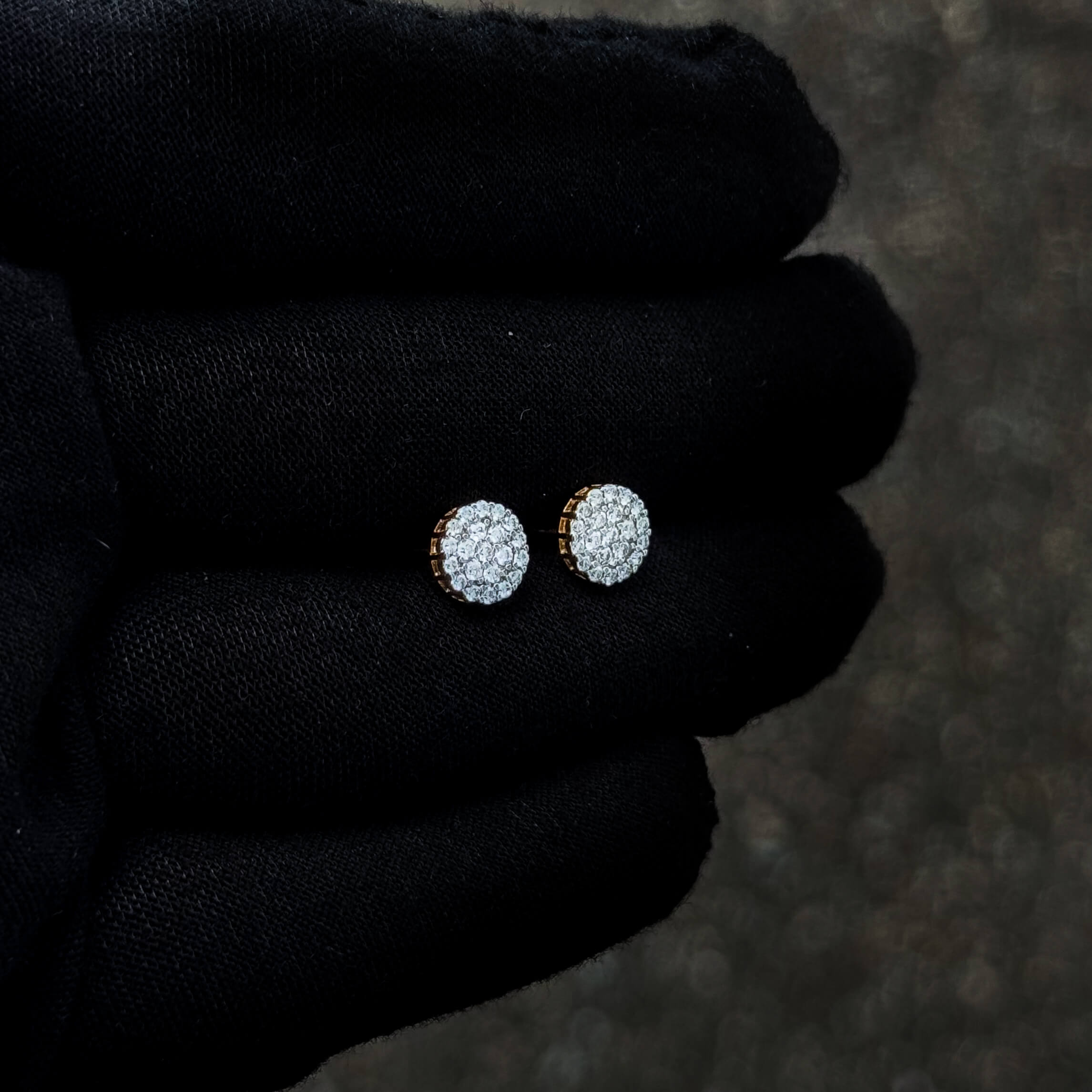 Side-angle view of 0.57ct Moissanite cluster earrings in sterling silver with gold-toned backing.