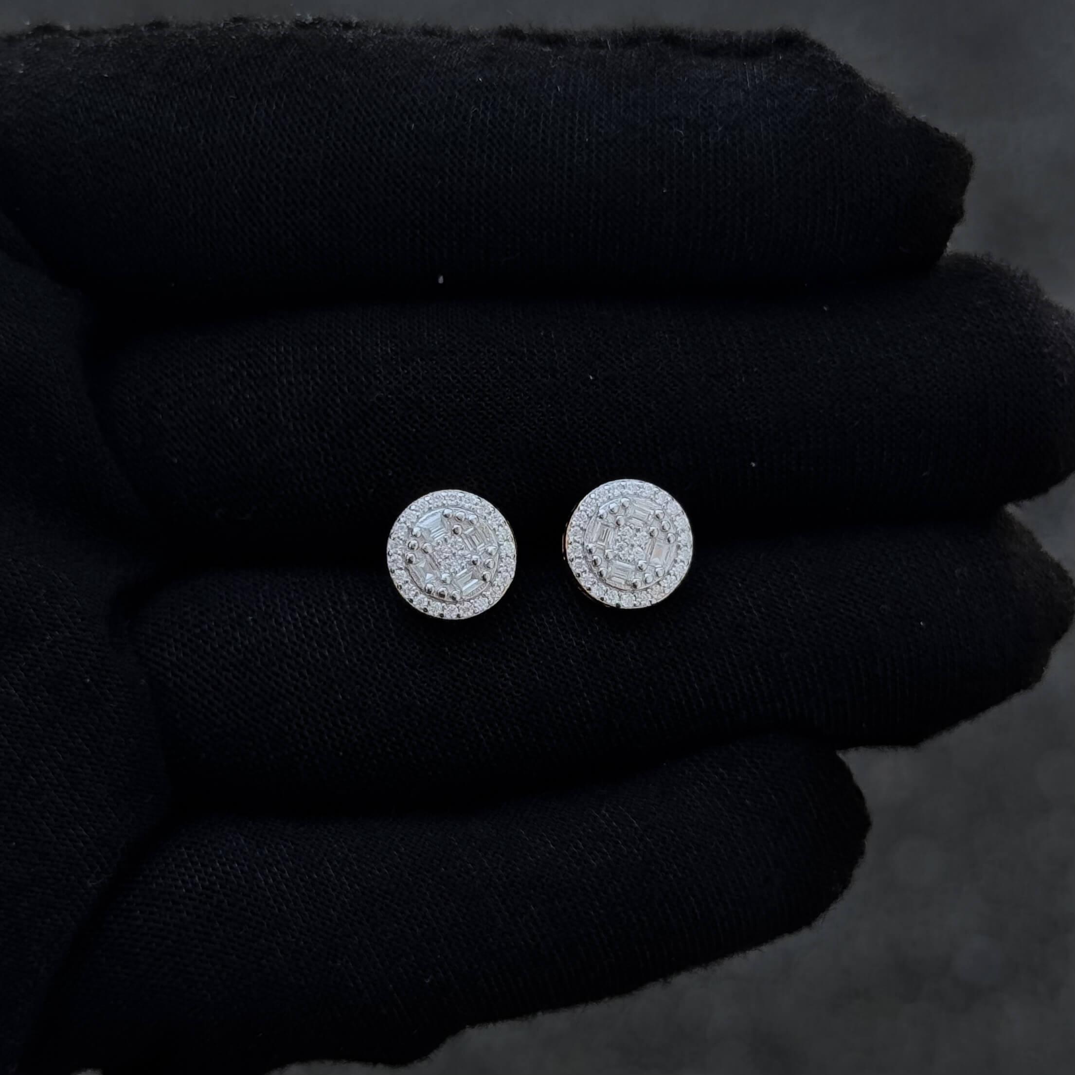 Small round Moissanite diamond cluster stud earrings displayed on black glove for detail view.