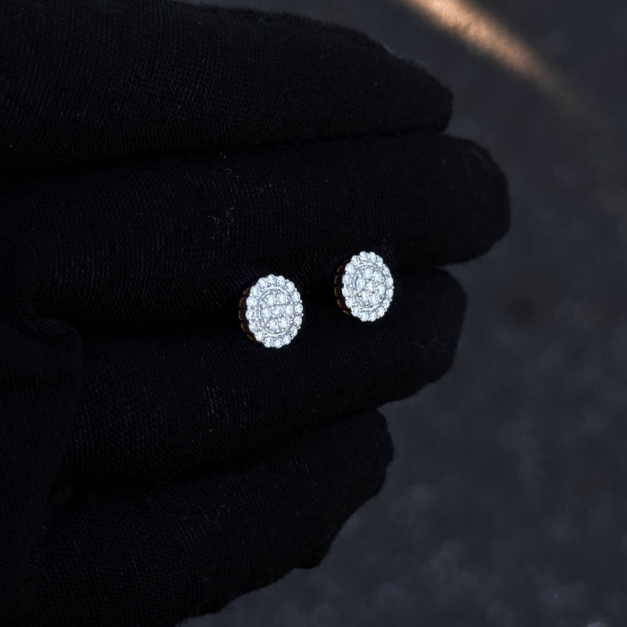 Gold-accent 8mm moissanite cluster stud earrings with sterling silver diamond halo detail.