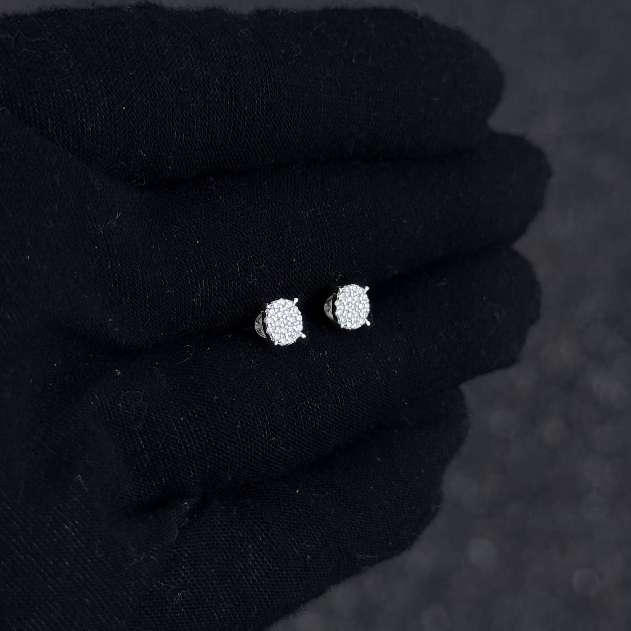 5mm Moissanite diamond cluster studs in silver displayed on black glove background.