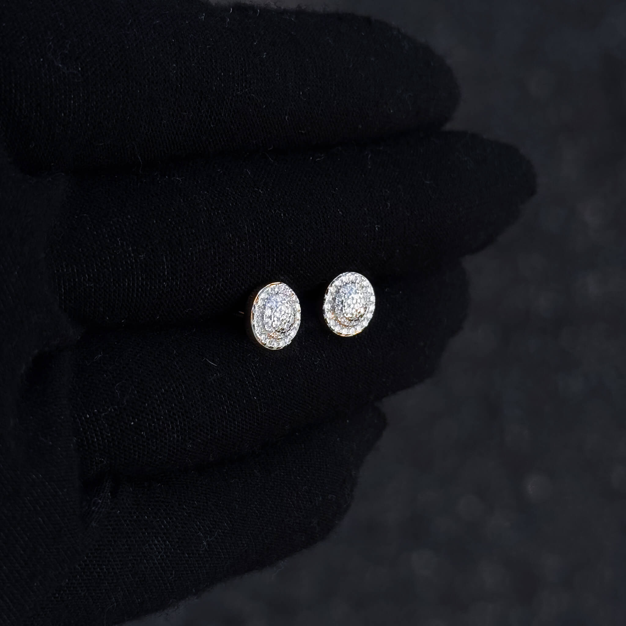 Small 8mm Moissanite cluster diamond studs shown on black glove with gold-tone backing.