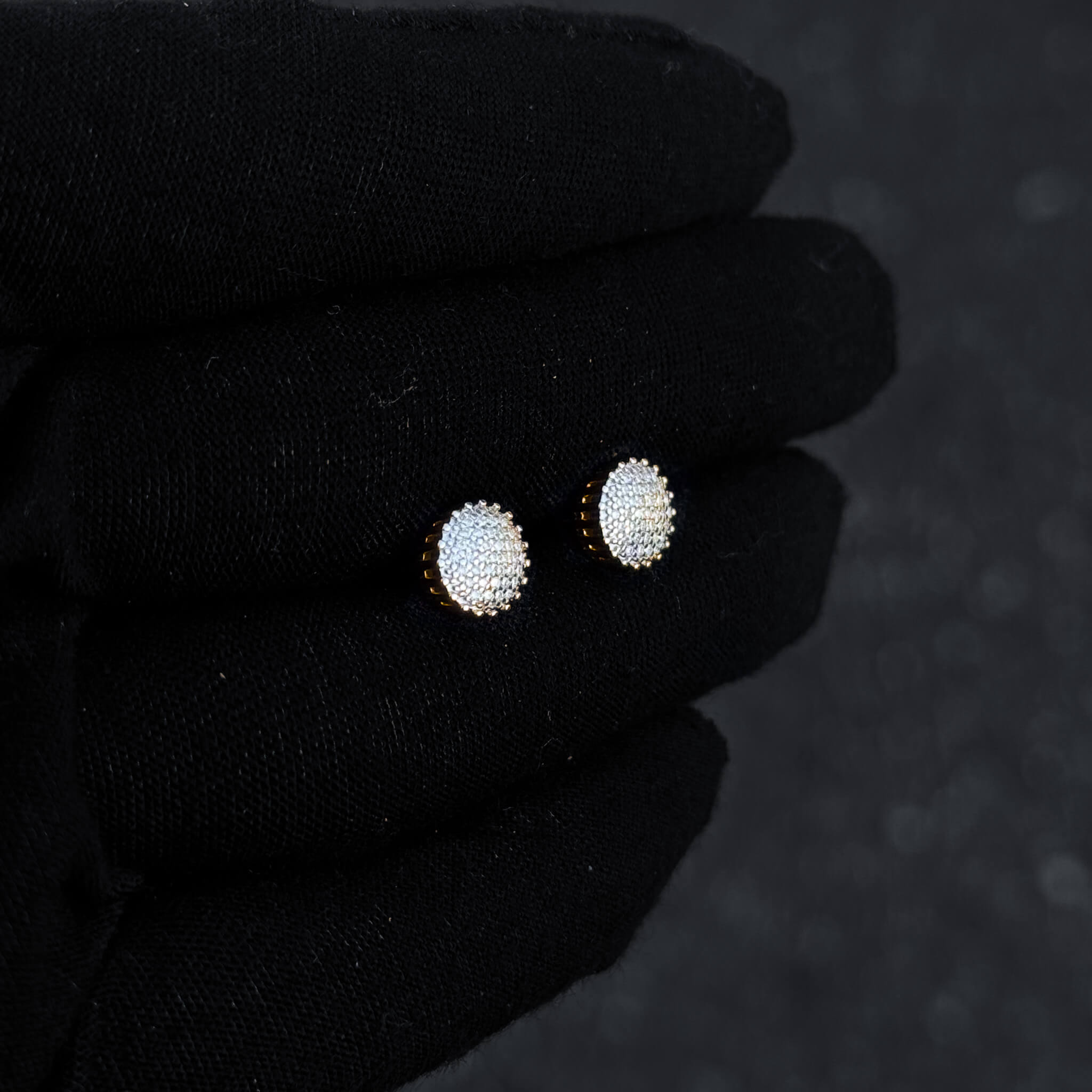 Gold-plated 8mm moissanite cluster stud earrings shown on display, sparkling diamond detail.
