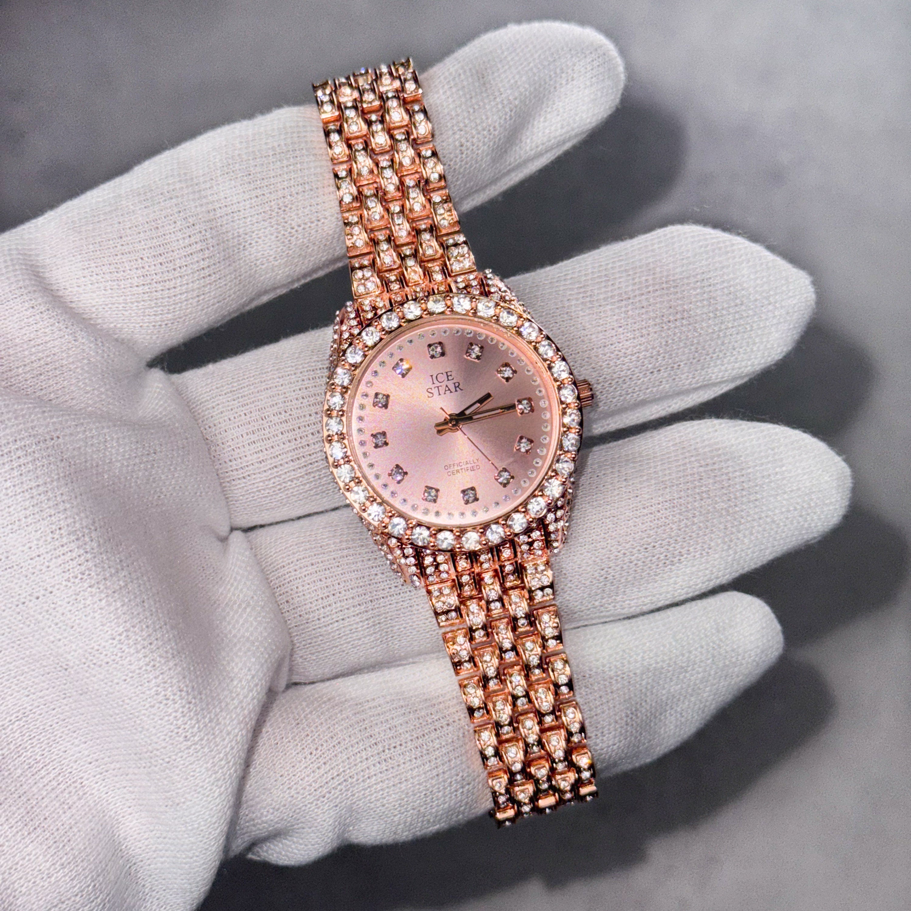Rose gold Women’s 32mm diamond watch with pink dial, iced bezel and multi-row crystal band.