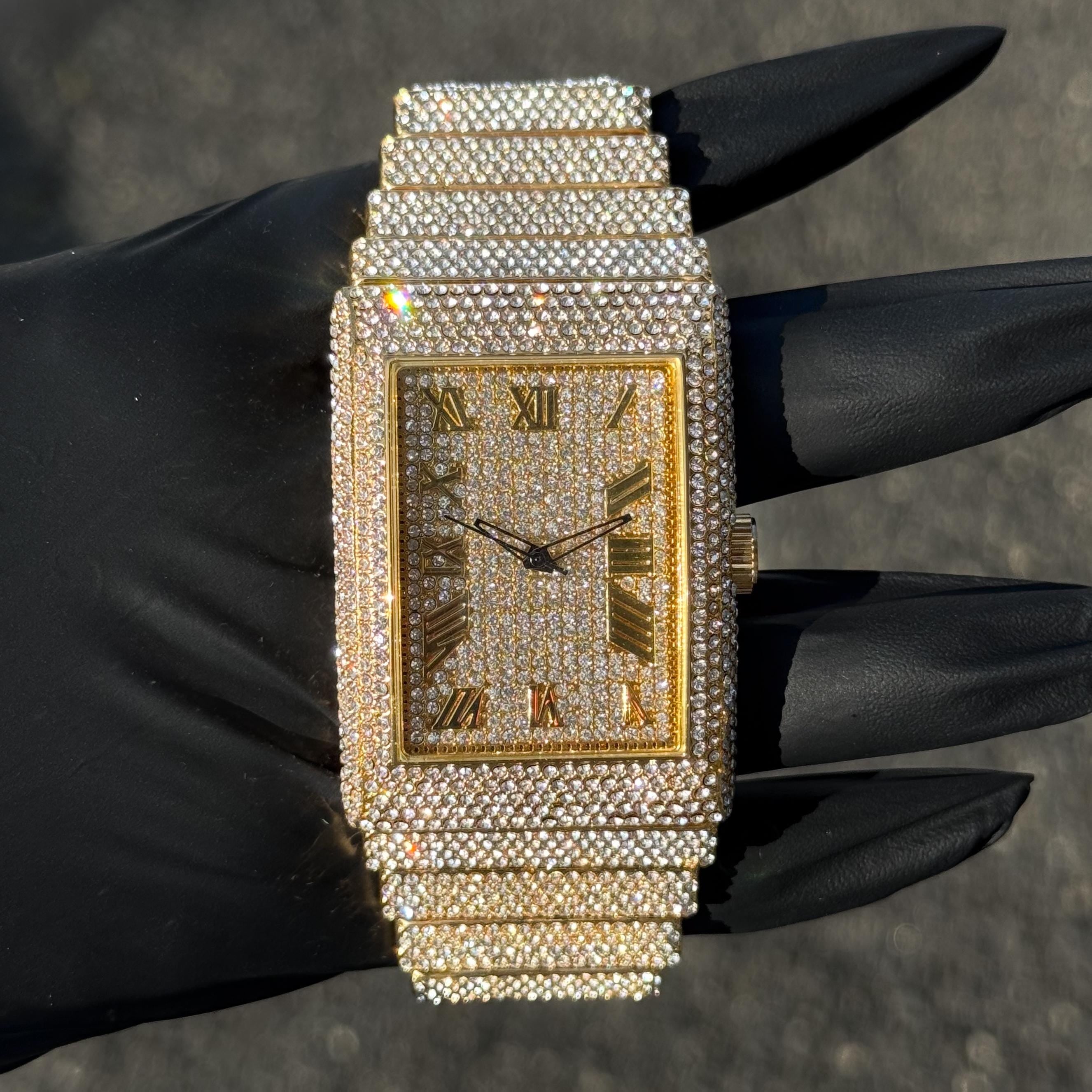 Gold men’s 40mm fully iced diamond watch with rectangular case, Roman numerals, and iced bezel.