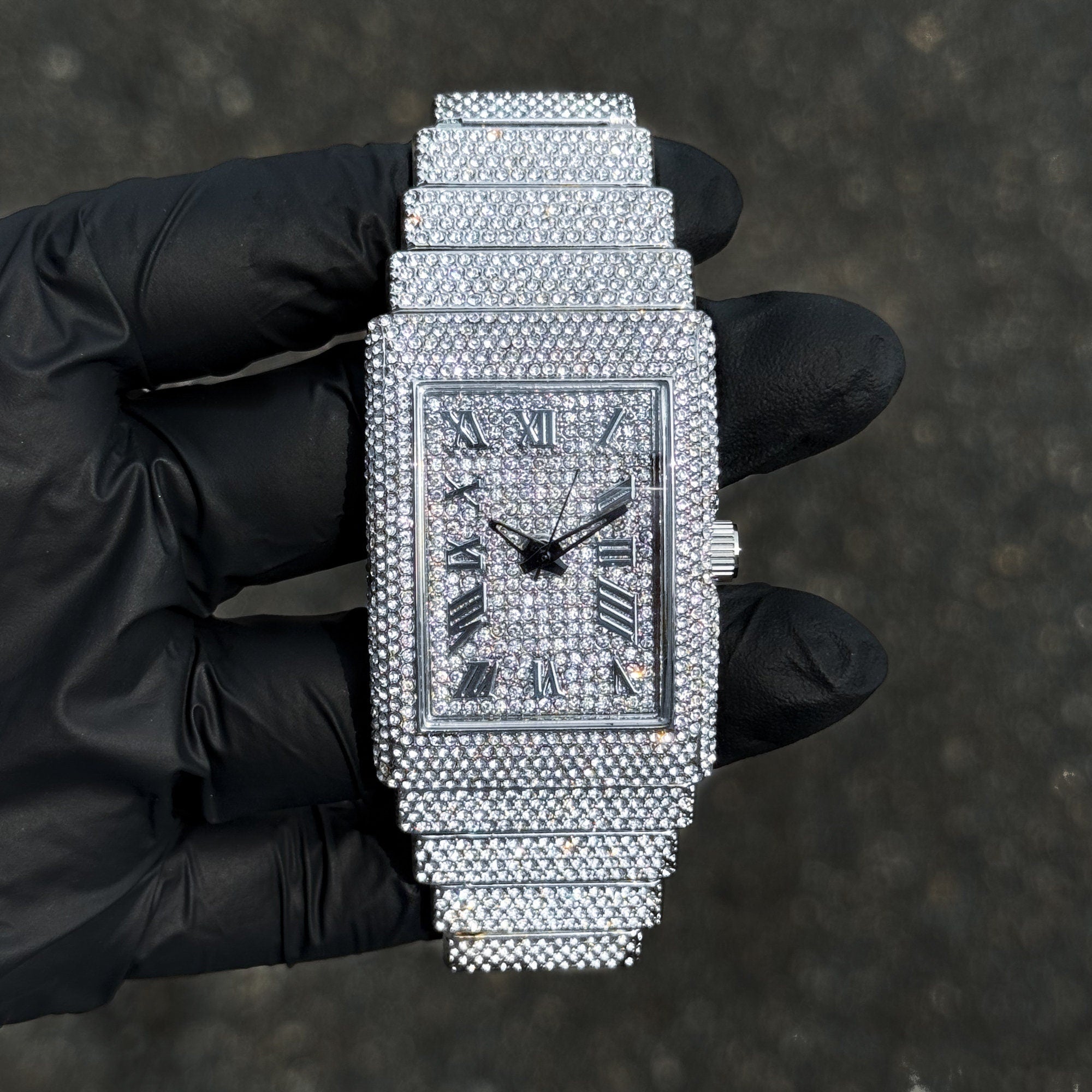 Women's 33mm silver fully iced diamond watch with rectangle face and chandelier bracelet.