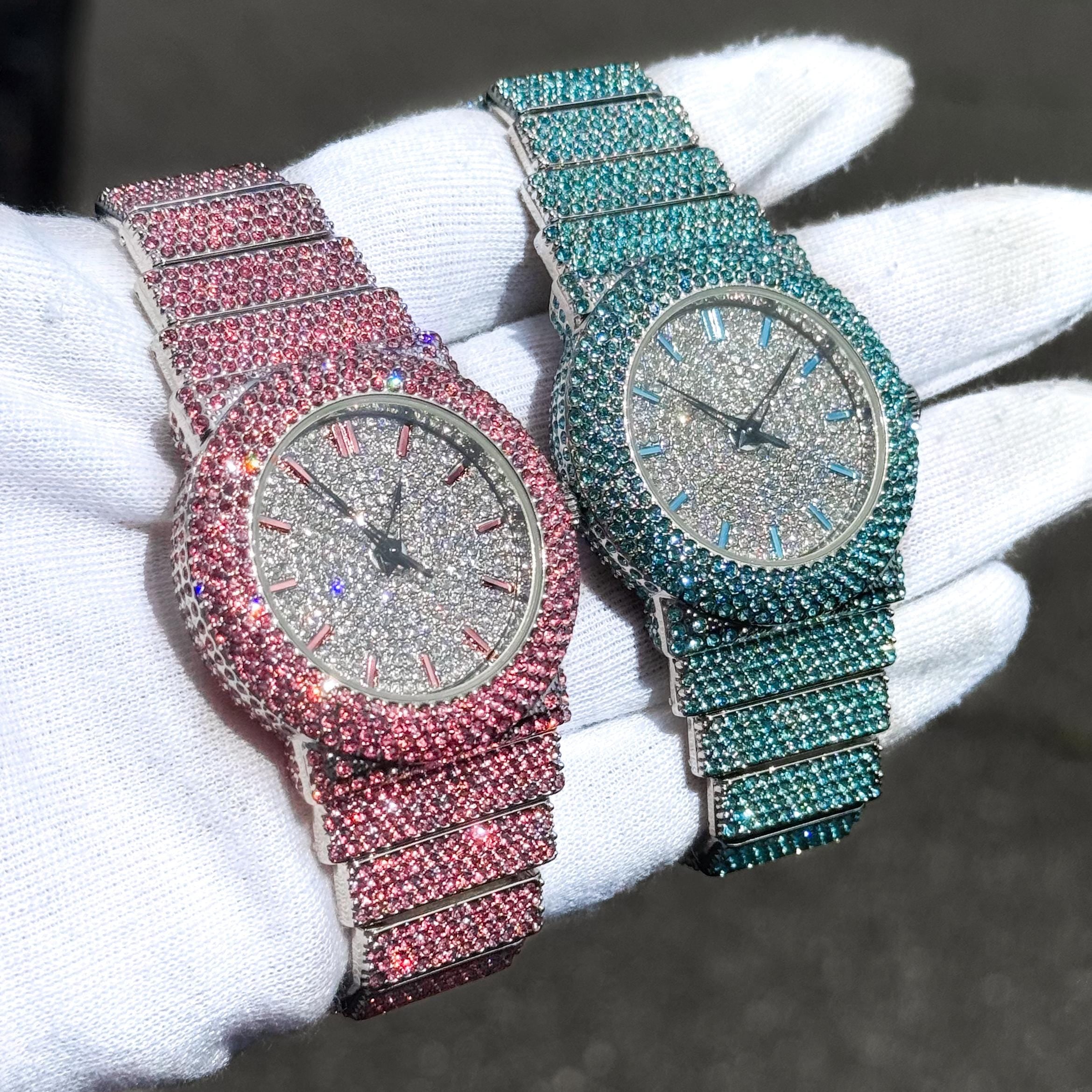 Pink and aqua Women's 40mm iced diamond watches featuring full crystal bands and shimmering dials.