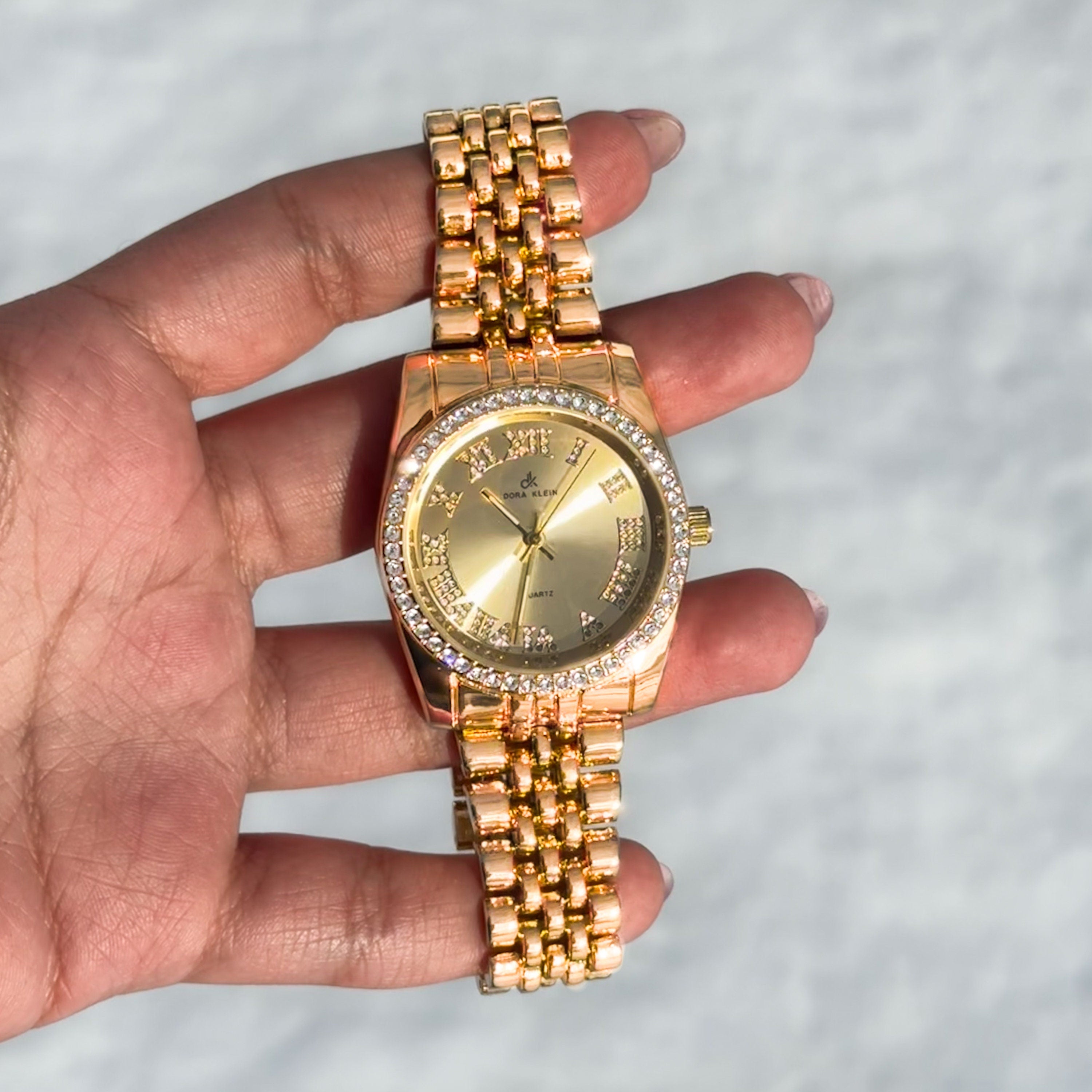 Gold Women's 35mm sleek metal band watch featuring Roman numeral dial and crystal-studded bezel.