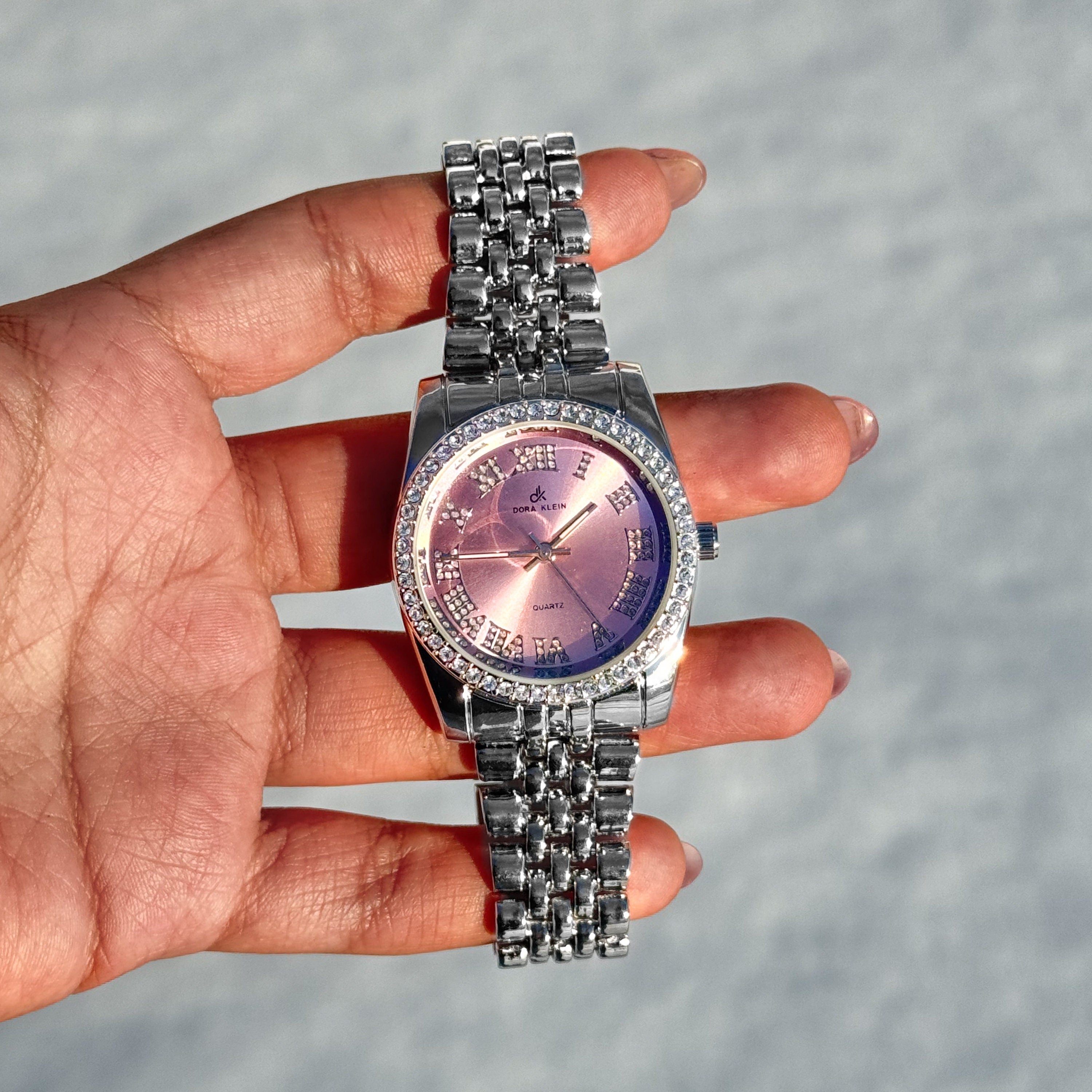 Silver Women's 35mm Roman numeral watch with pink dial and crystal-lined bezel, quartz movement.