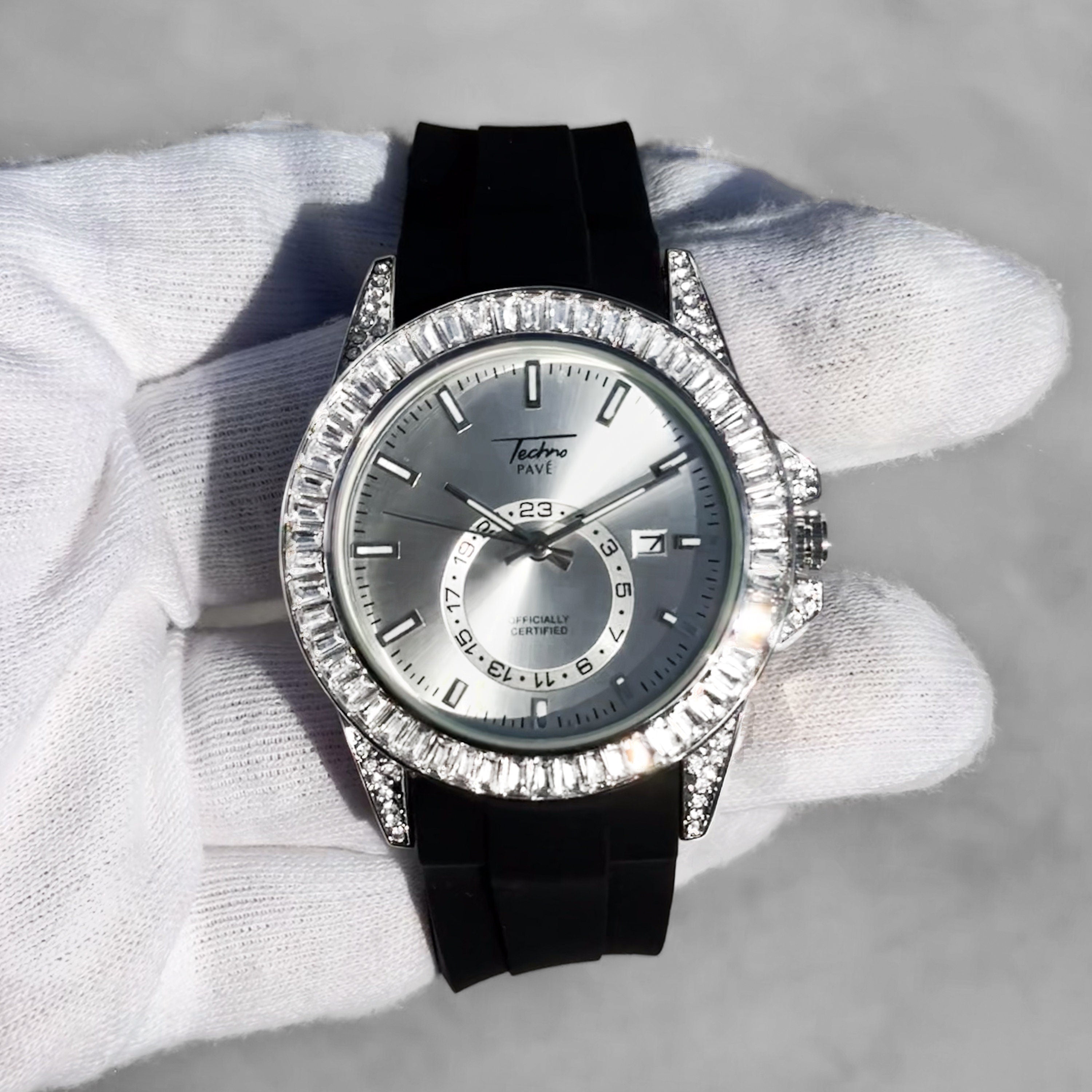 Men’s 42mm silver diamond watch featuring iced baguette bezel, silicone band, and clean quartz display.