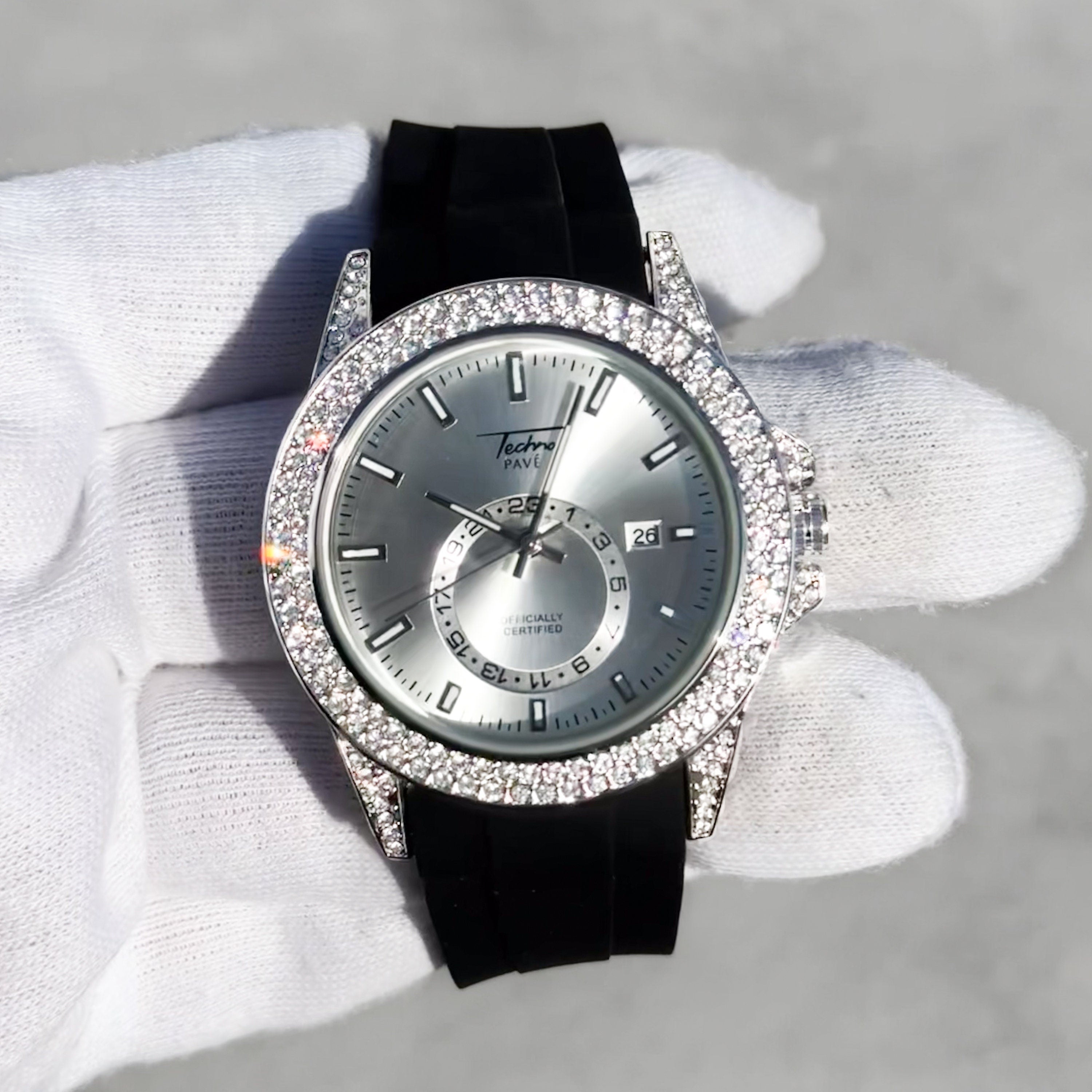 Men’s 42mm silver diamond watch with iced bezel, metallic silver dial, and black silicone band.