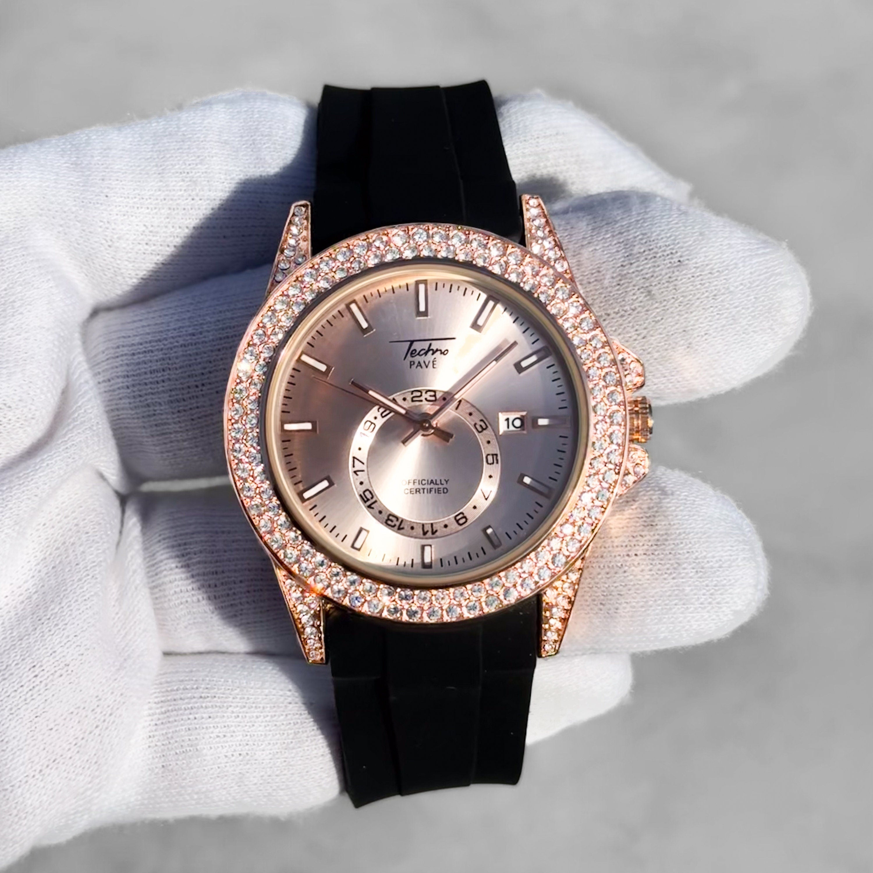 Men’s 42mm rose gold diamond watch with iced-out bezel, sunray dial, and black silicone strap.