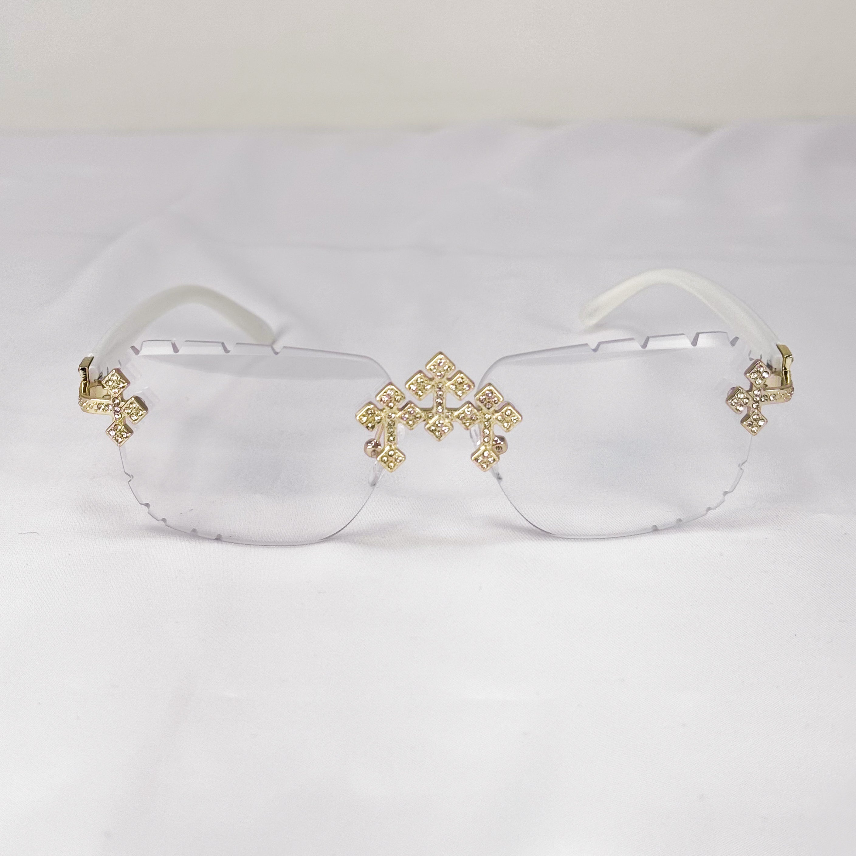 Rimless clear Triple Cross Sunglasses in white with gold iced cross detailing on frames.
