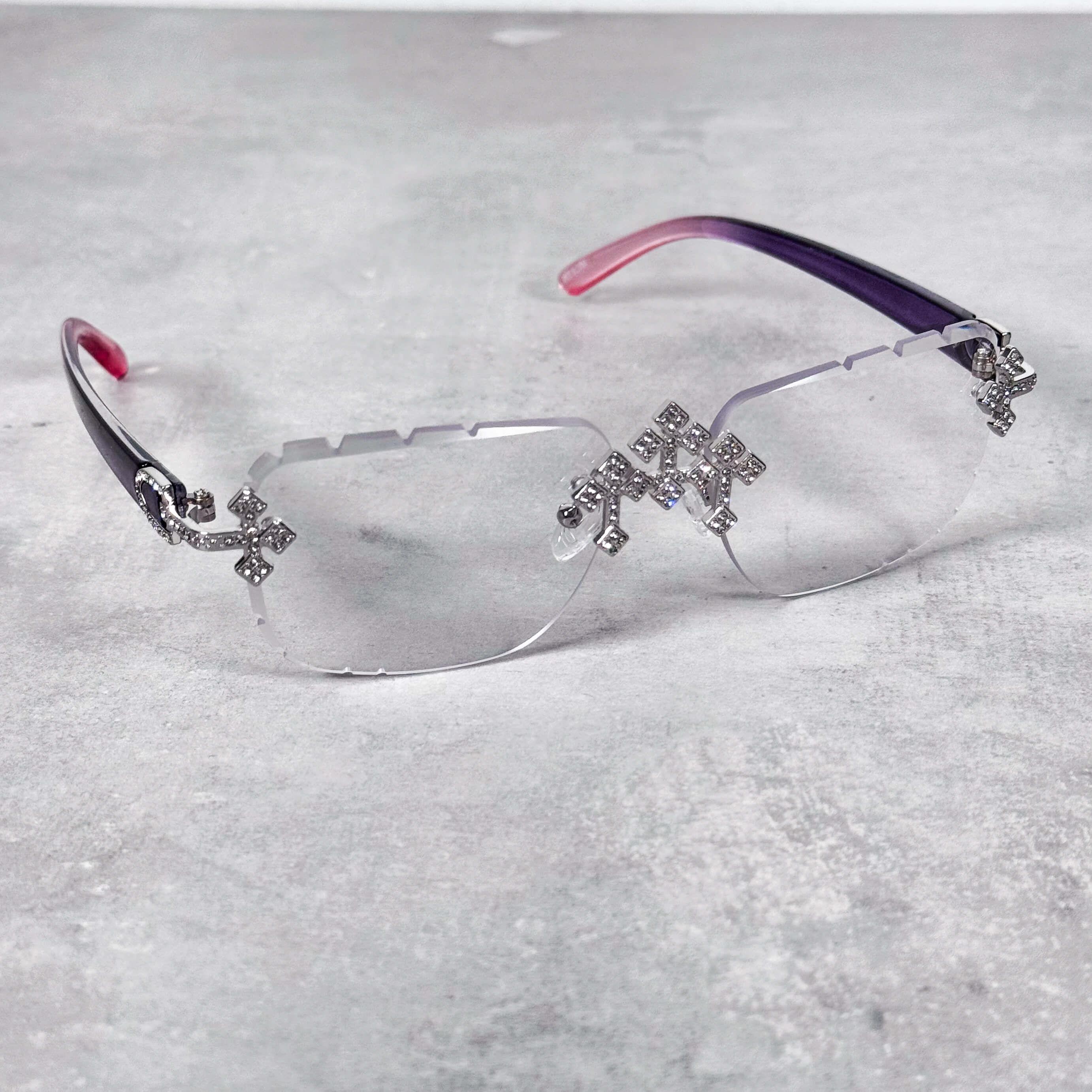 Clear lens Iced Triple Cross Sunglasses featuring crystal cross accents and curved purple arms.