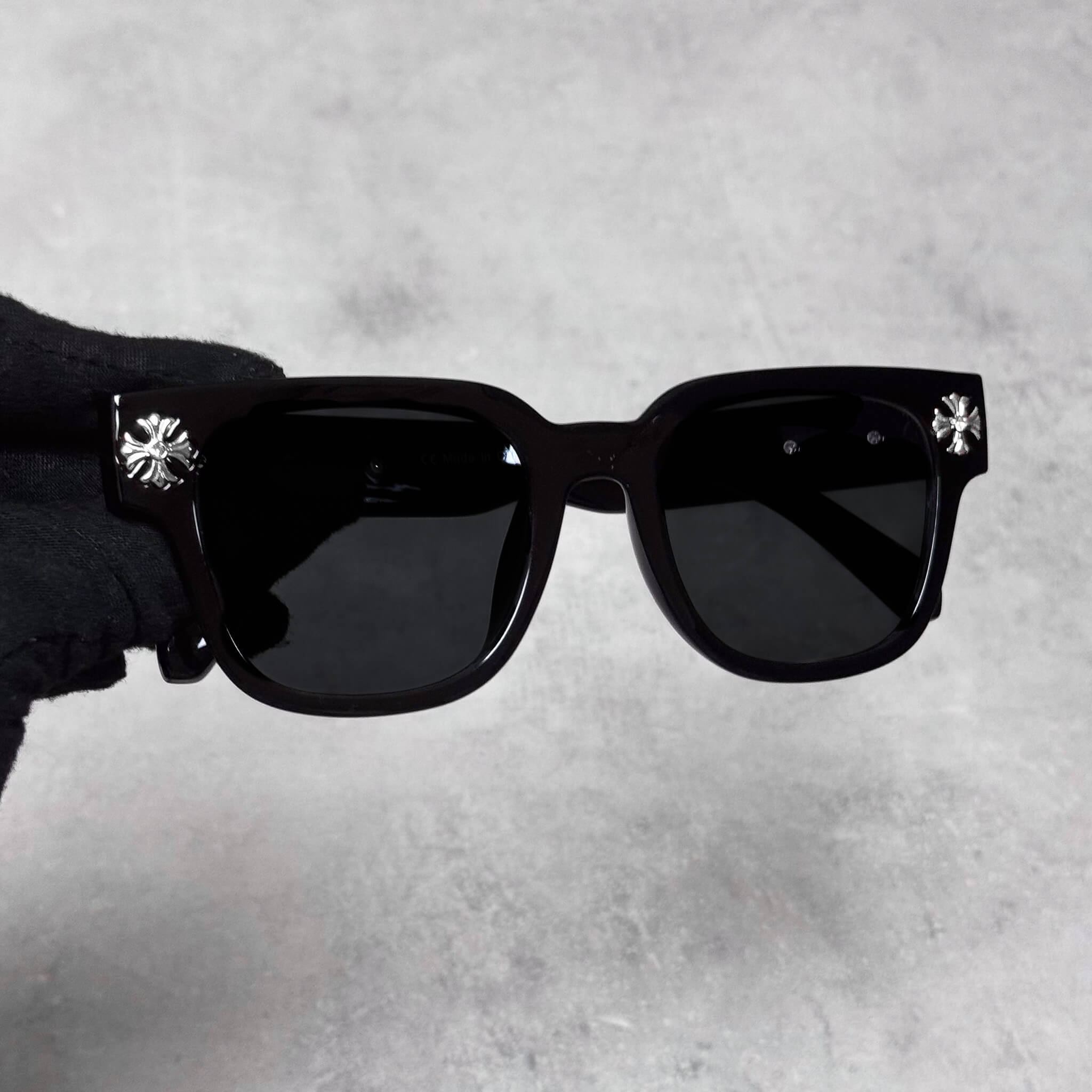 Front view of Cross Chrome Inspired Sunglasses with silver cross accents and black glossy frame.
