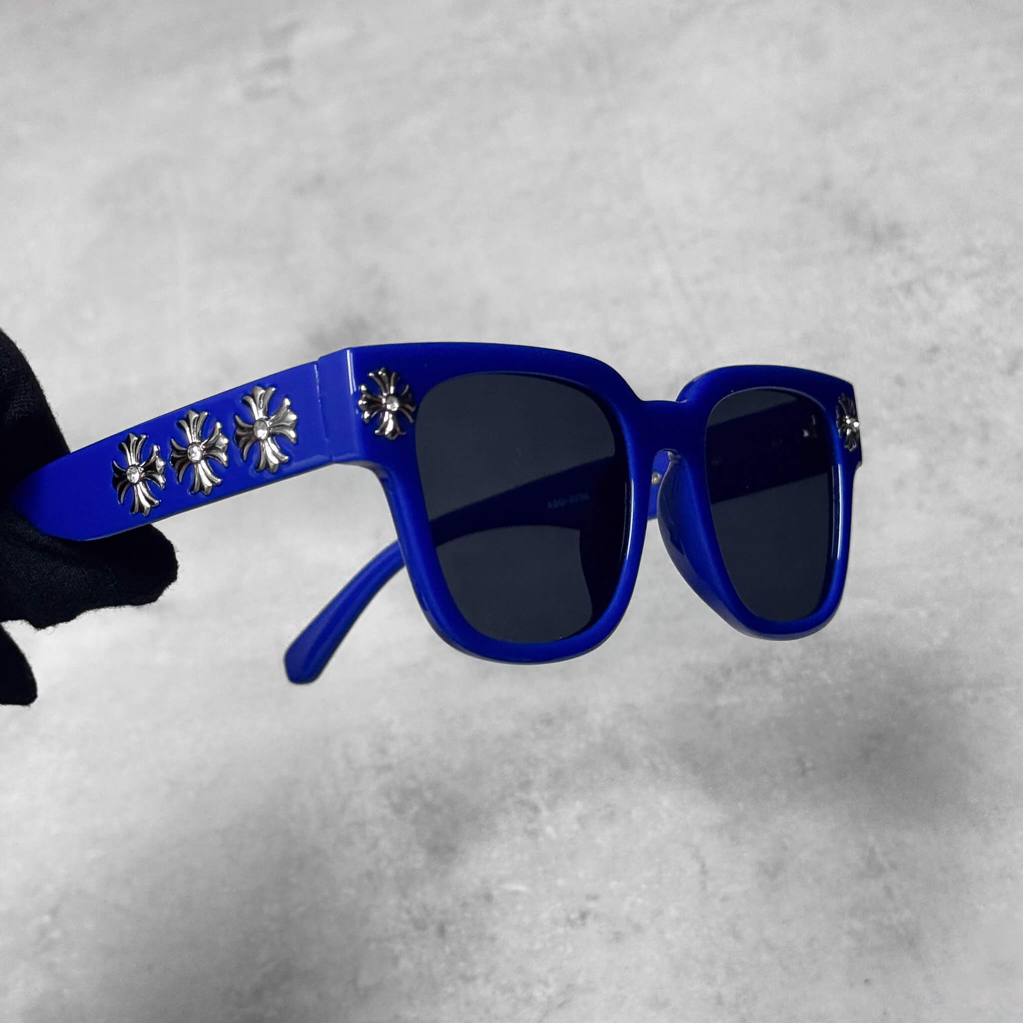 Side view of blue Cross Chrome Inspired Sunglasses featuring silver cross detailing.