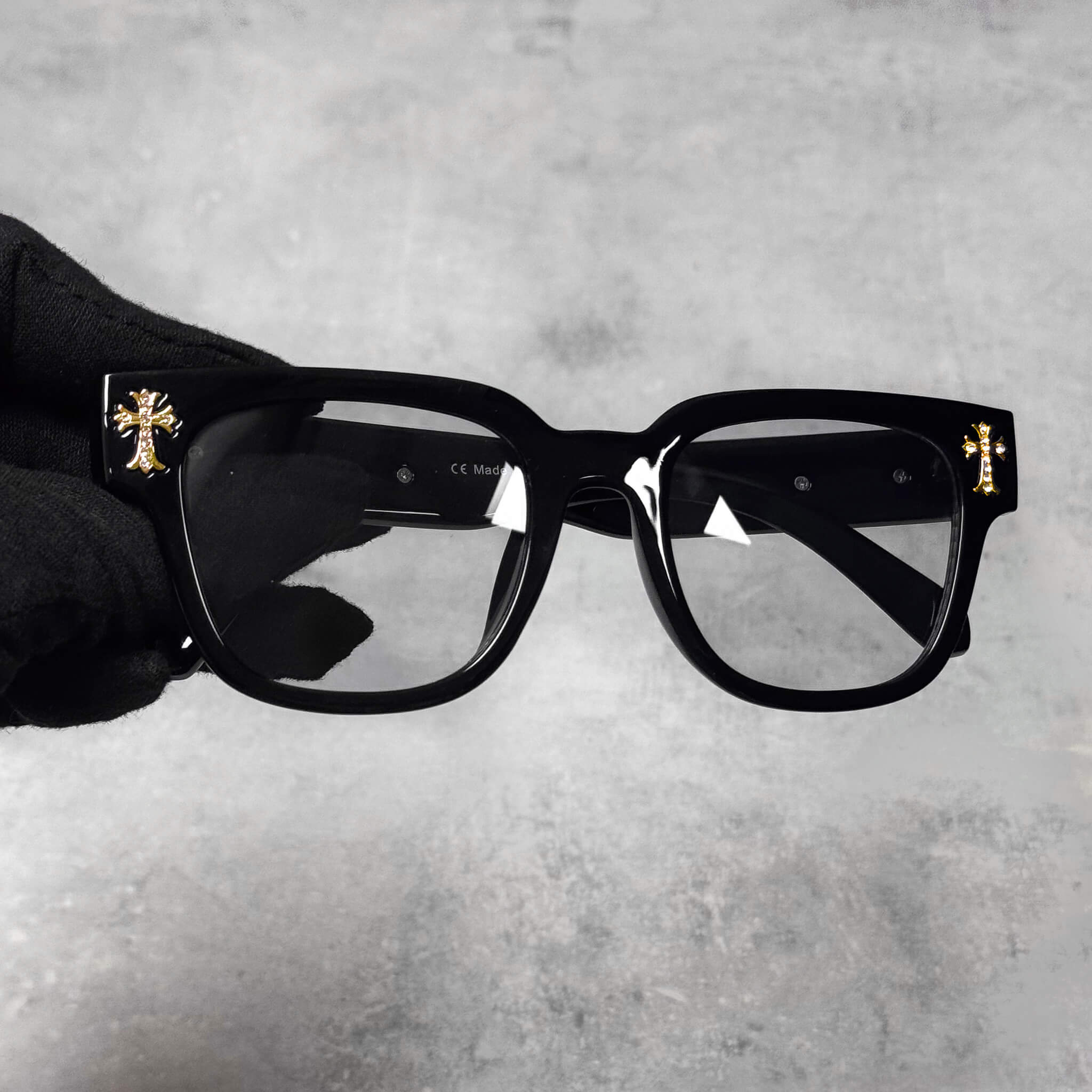 Black smoke-lens Triple Cross Chrome Inspired Sunglasses featuring gold metal cross details on frame.
