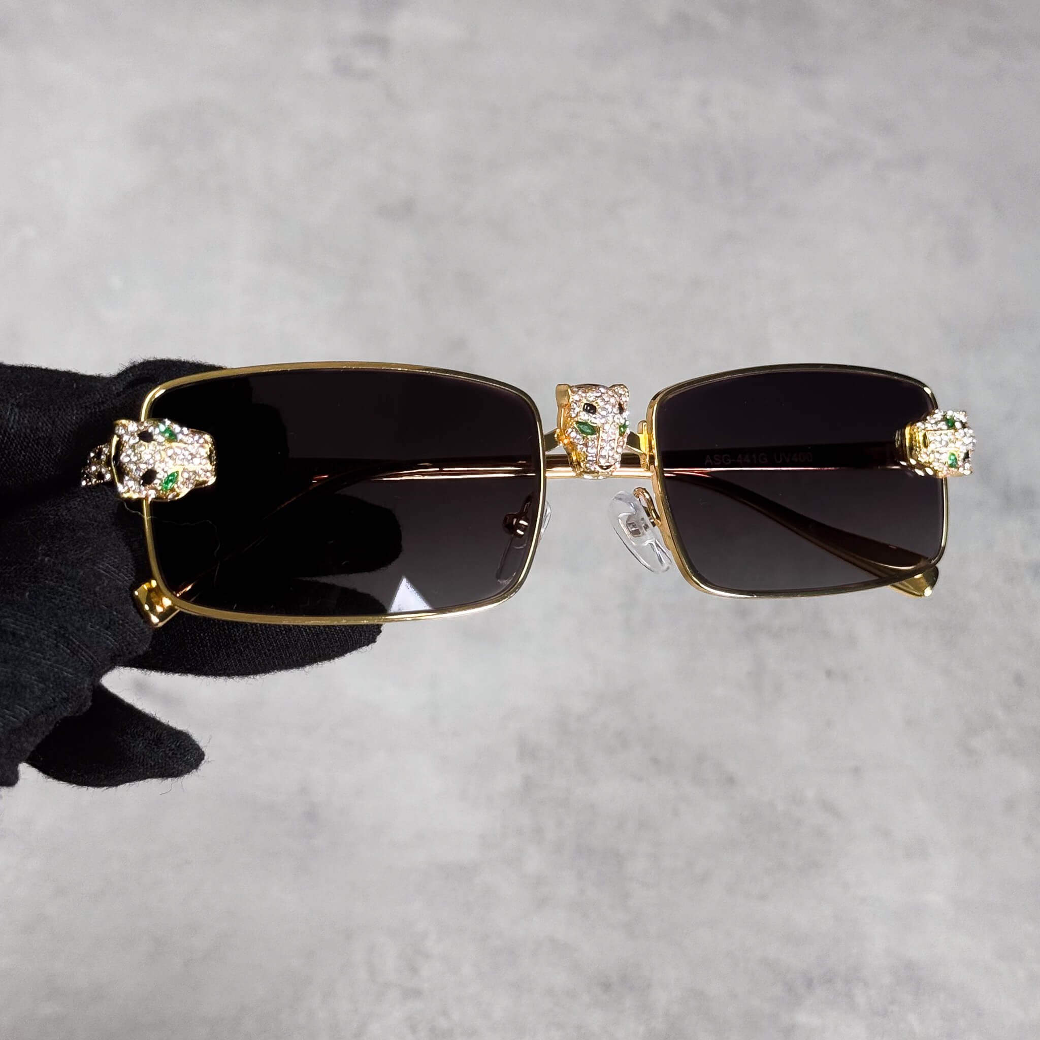 Iced Out Panther Sunglasses in gold with black lenses and crystal panther heads on the frame.